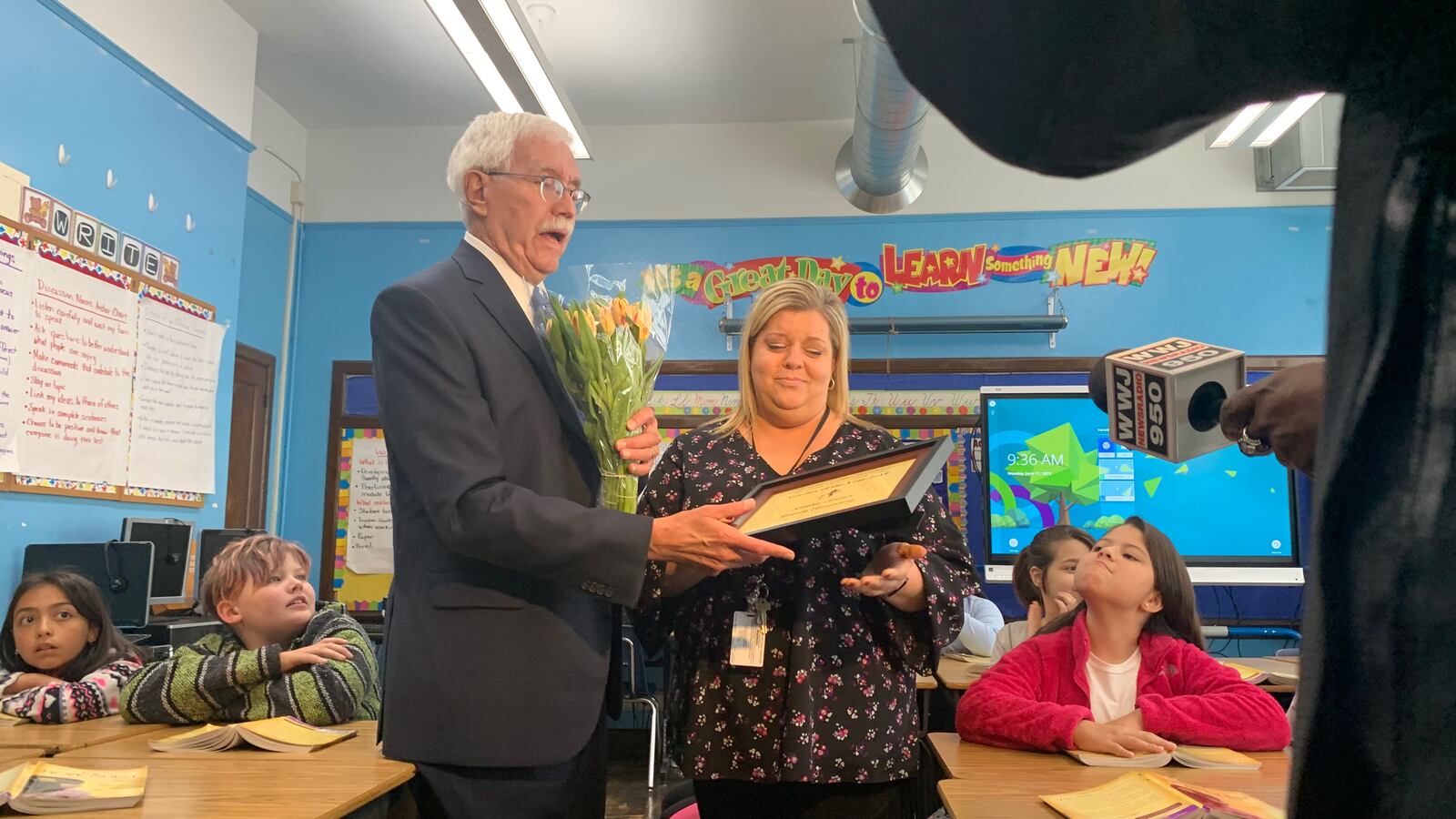 Detroit Goodfellows President Marshall Hunt presents Sandra Limmer with the Teacher of the Year award.