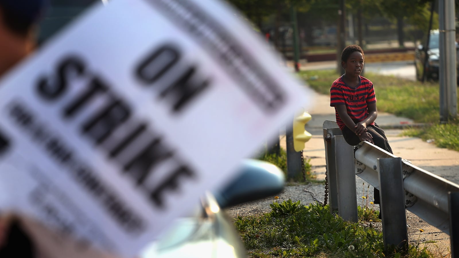 A third grader watches Chicago teachers as they picket outside his school in the fall of 2012.