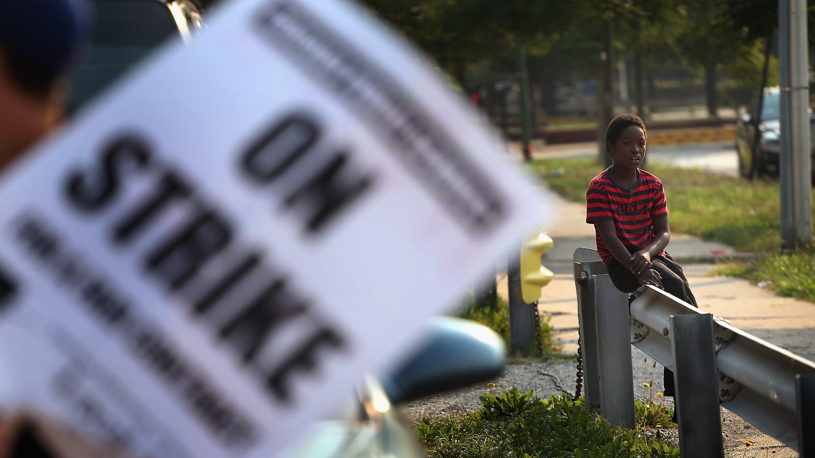 A third grader watches Chicago teachers as they picket outside his school in the fall of 2012.