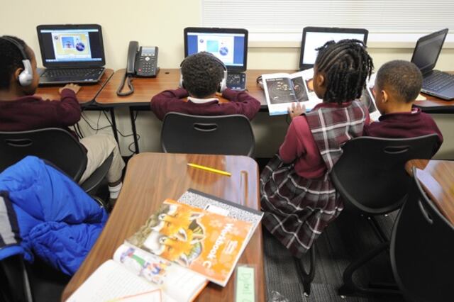 Second-graders work on computers at Tindley.