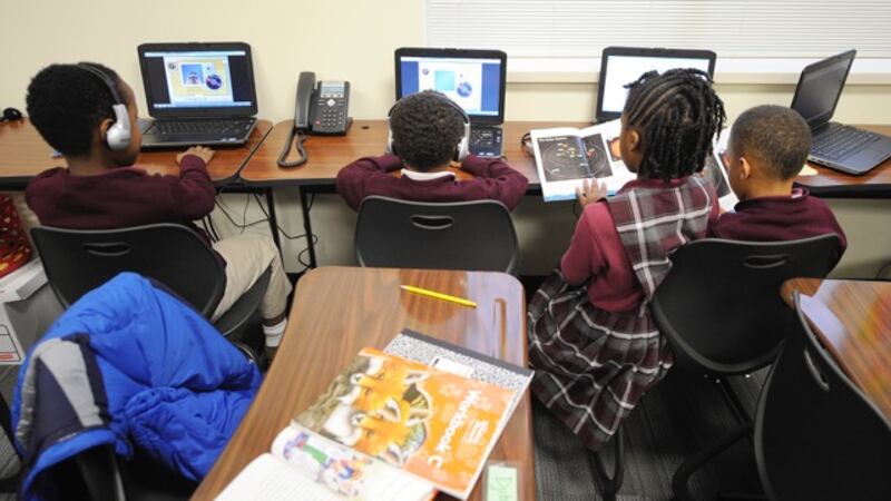 Second-graders work on computers at Tindley.