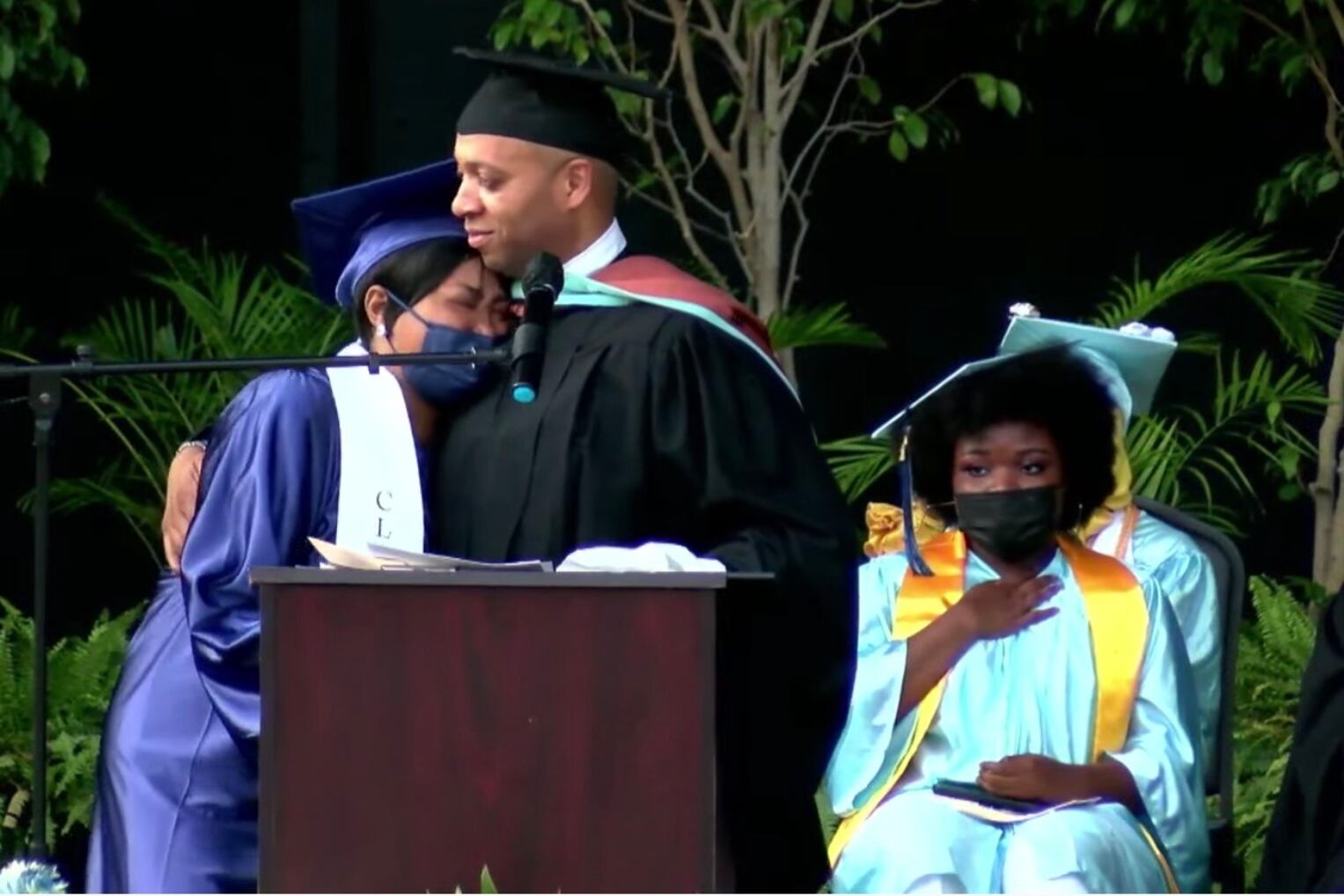 Richard Gordon, principal of Paul Robeson High School, consoles Tawanda Robinson, mother of David Williams.