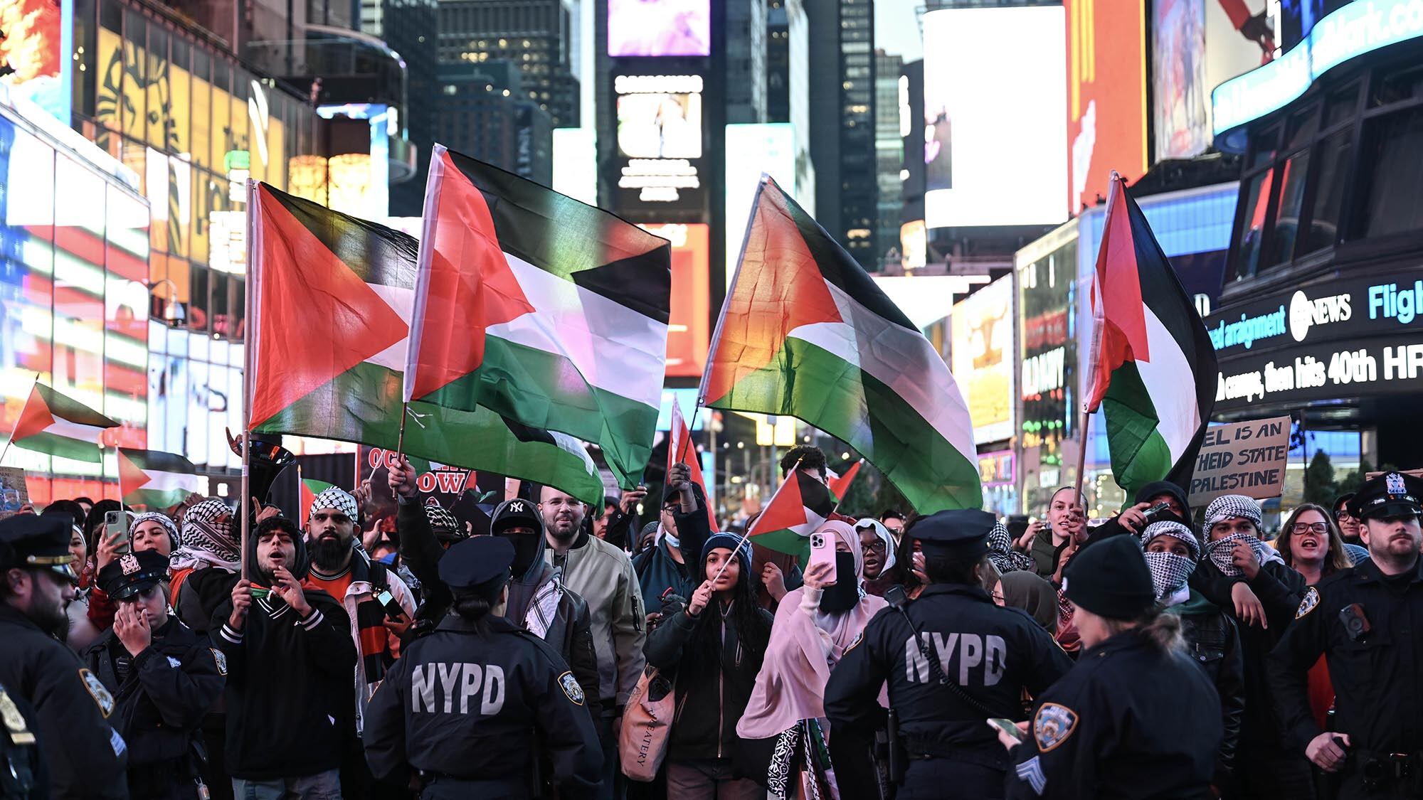 Protestors march with Palestinian flags in New York City.