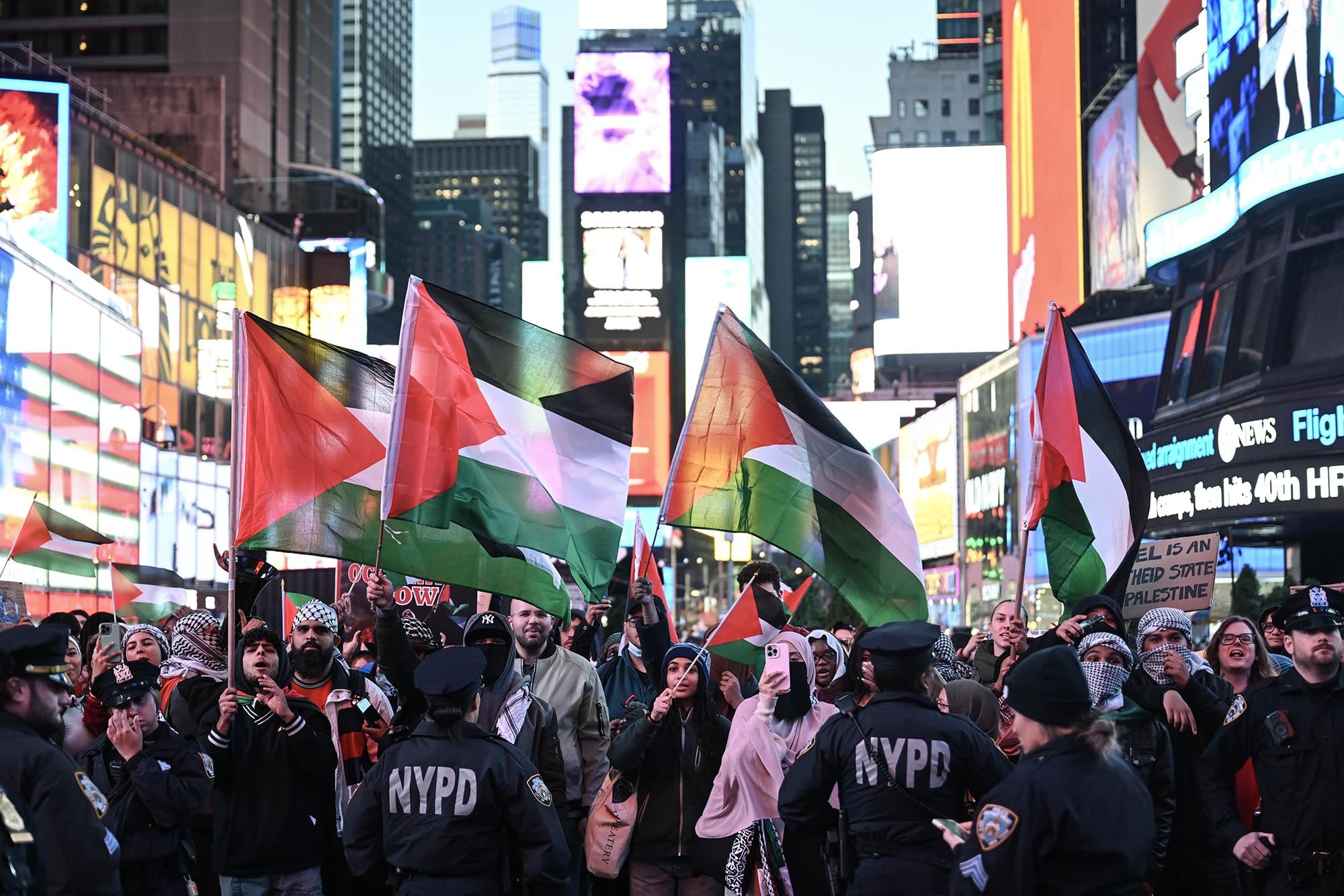 Protestors march with Palestinian flags in New York City.