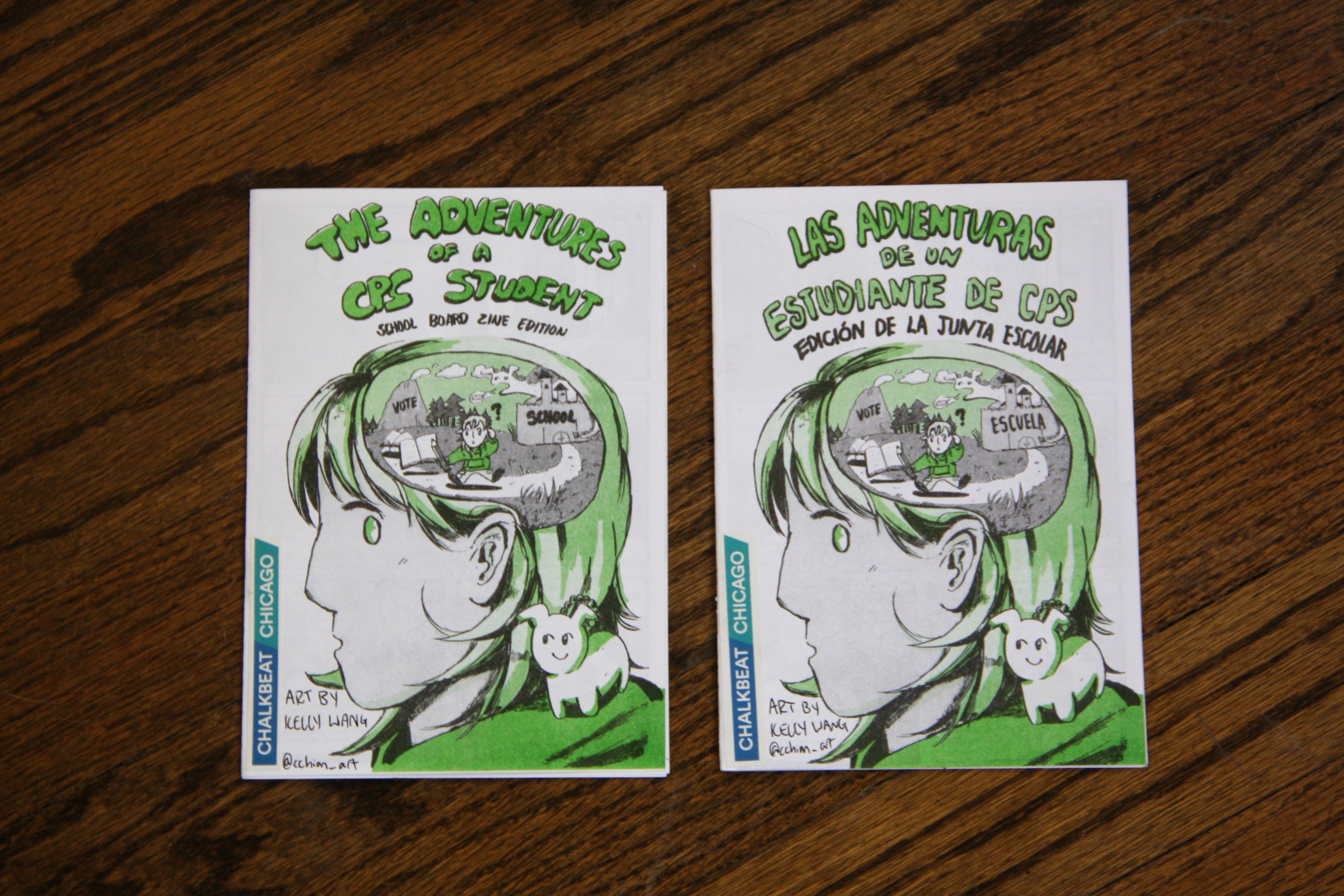 Two zines, one in English and Spanish sit side by side on a wooden table.