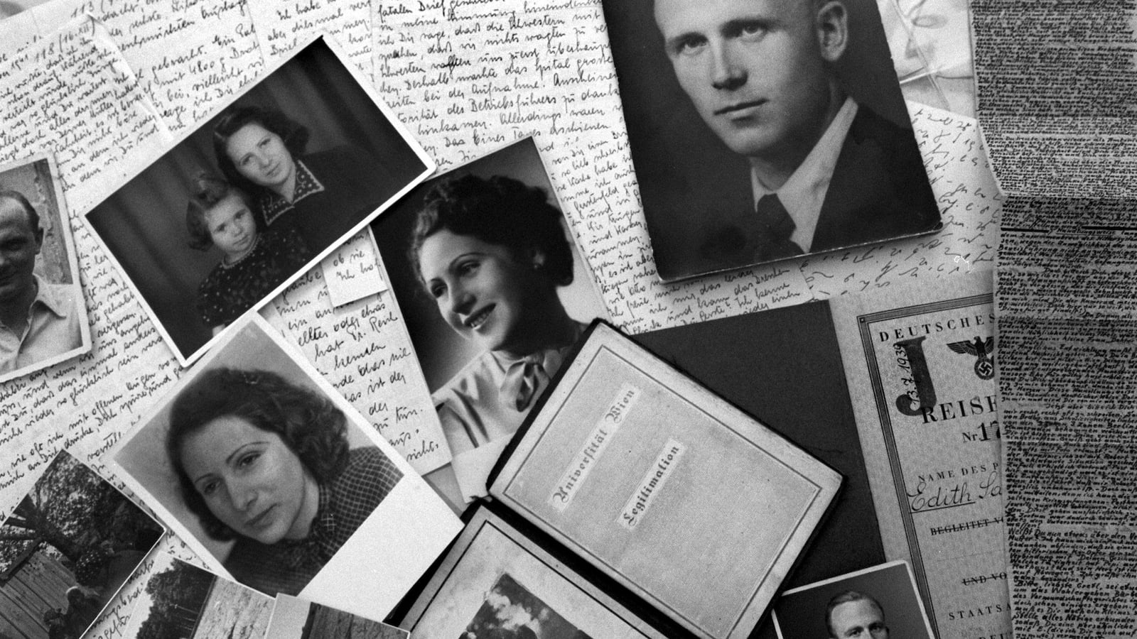 Photo depicts black and white family photographs scattered over hand-written letters and journals.