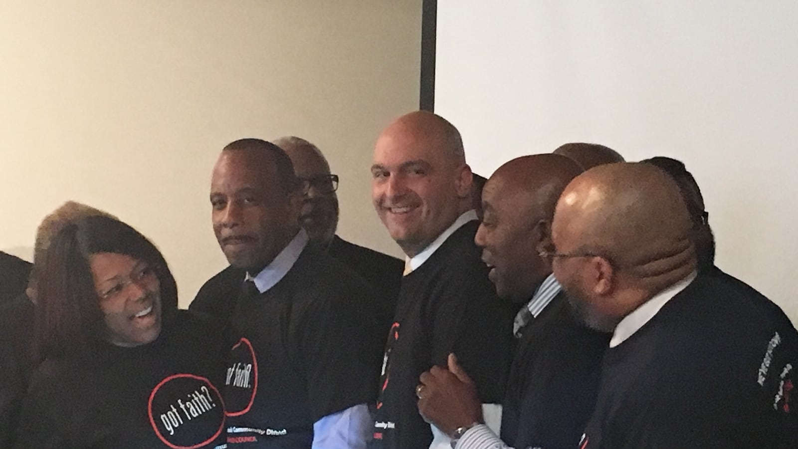 Superintendent Nikolai Vitti surrounded by religious and district leaders wearing new "Got Faith?" shirts.