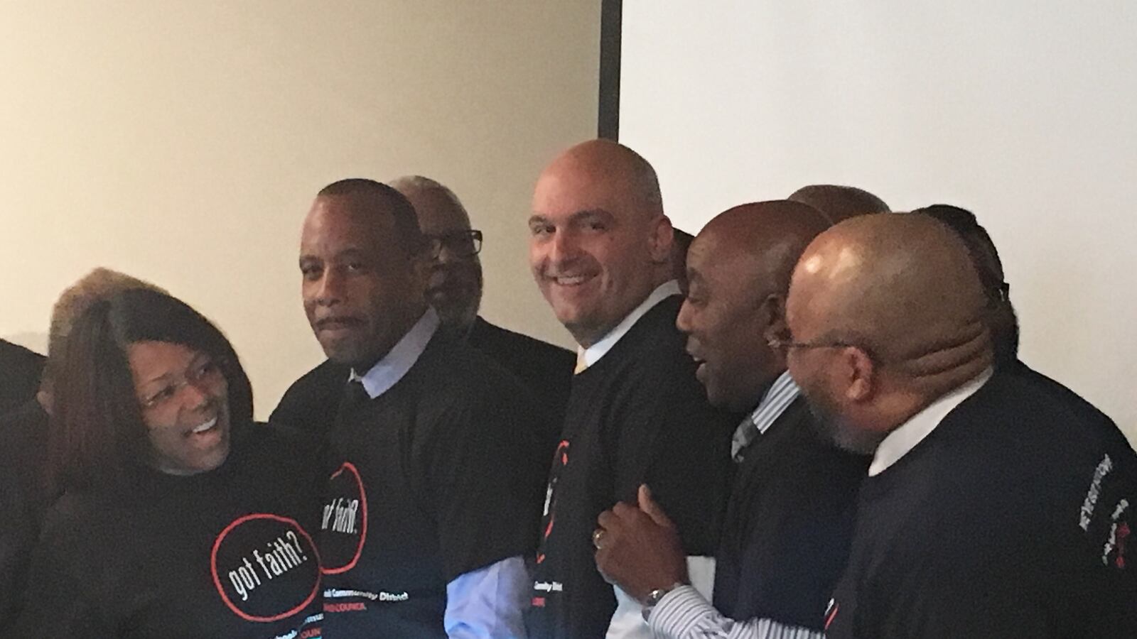 Superintendent Nikolai Vitti surrounded by religious and district leaders wearing new "Got Faith?" shirts.
