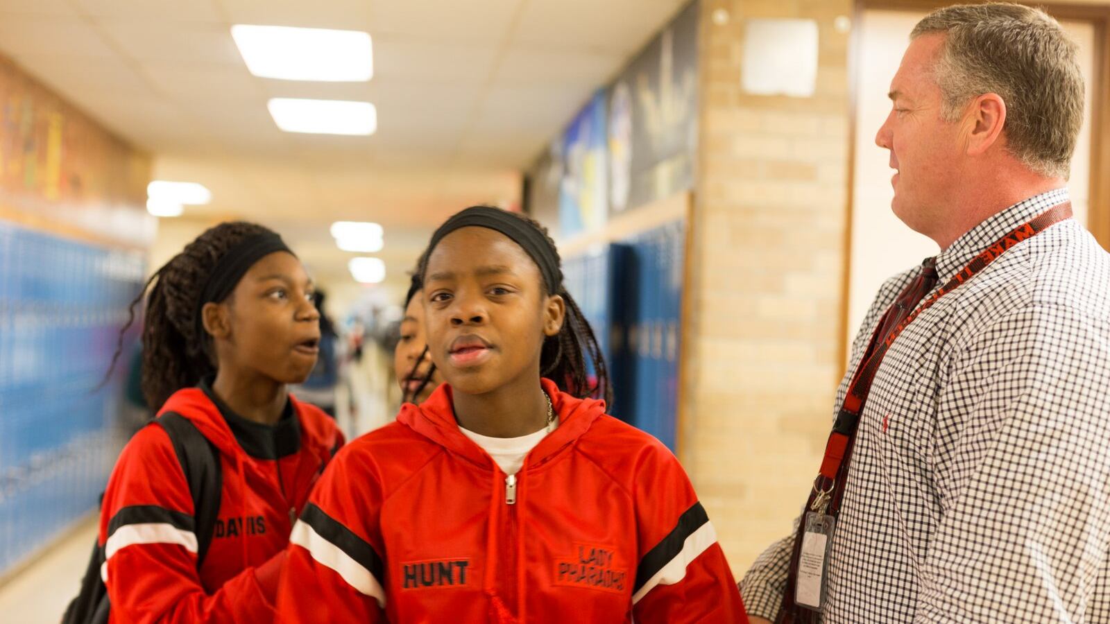 Principal Bo Griffin talks with students in the hallways of Raleigh Egypt High School. (Photo by Ruma Kumar/Chalkbeat)