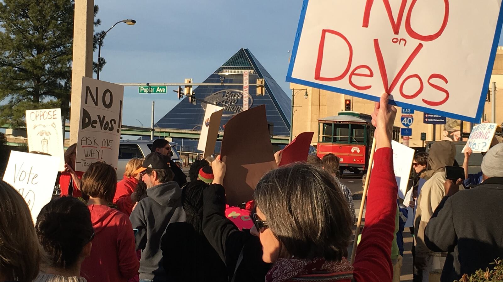 Citizens congregate Monday in front of U.S. Sen. Lamar Alexander's Memphis office to speak out against Betsy DeVos's nomination as the nation's next secretary of education.