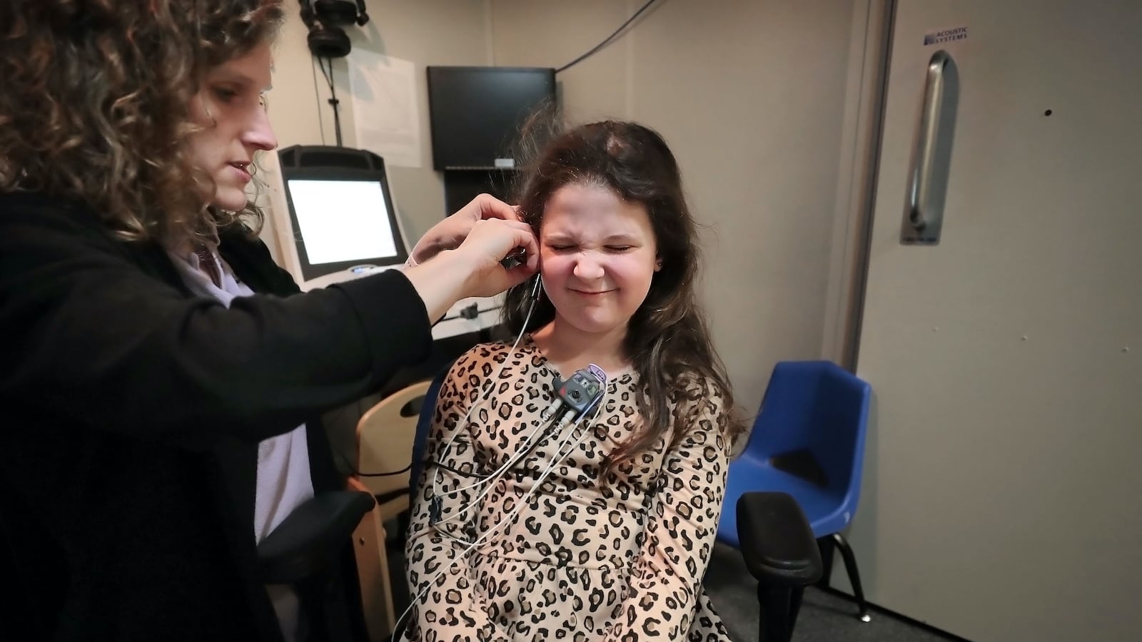 Eight-year-old Gigi Benassi winces as a pressure probe tickles her ear during a hearing test with audiologist Rachel Lunsford at the Memphis Oral School for the Deaf on Jan. 30, 2020. Gigi, who is moderately to severely deaf, is one of 164 students enrolled this school year in Tennessee's education savings account program for students with disabilities.