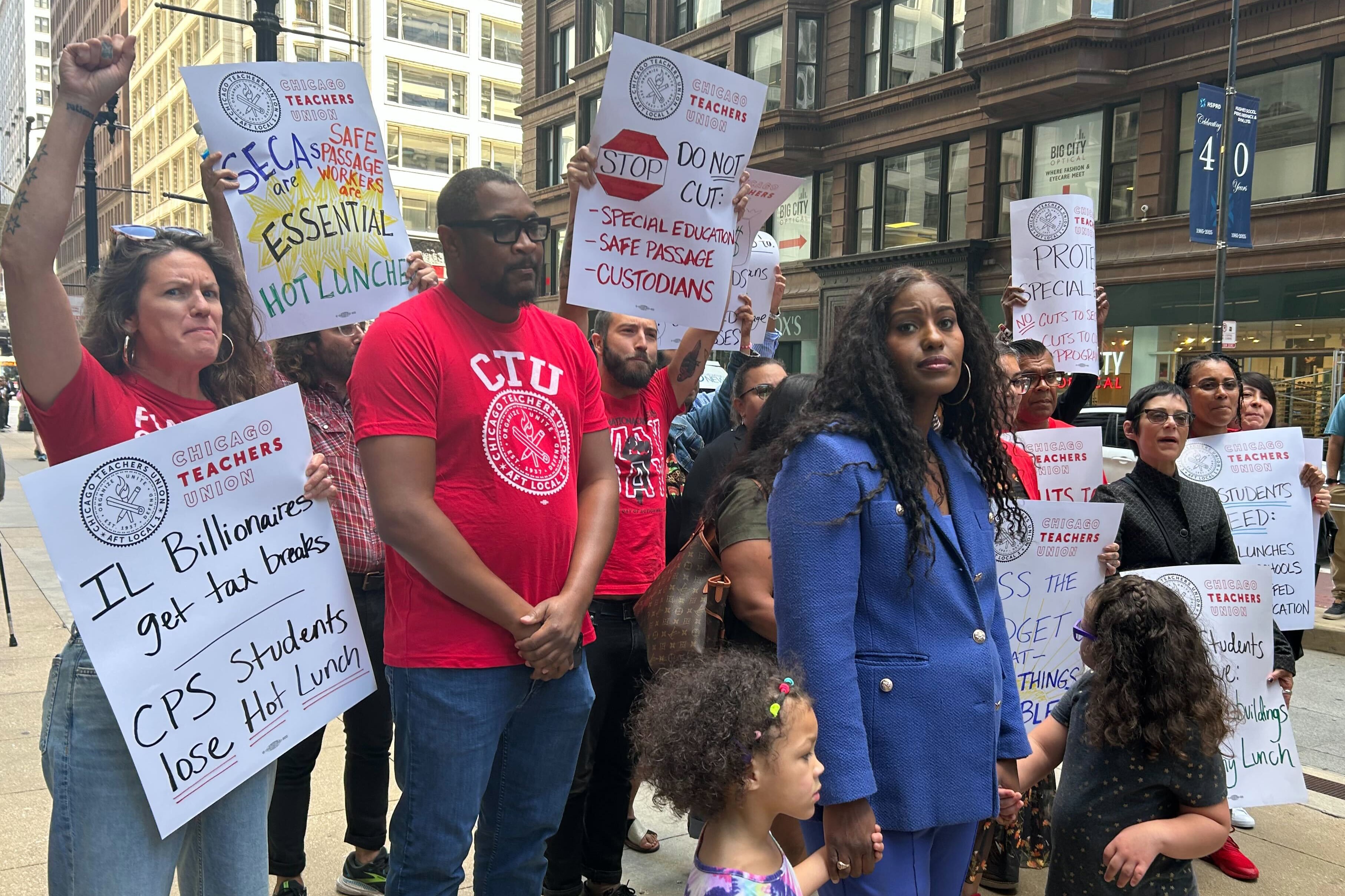 A group of people wearing red shirts standing outside.