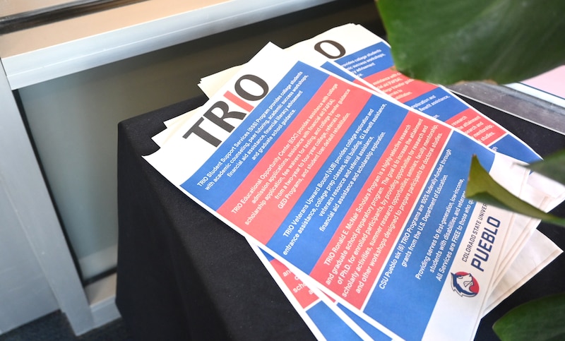 Fliers in red and blue sit on a table.