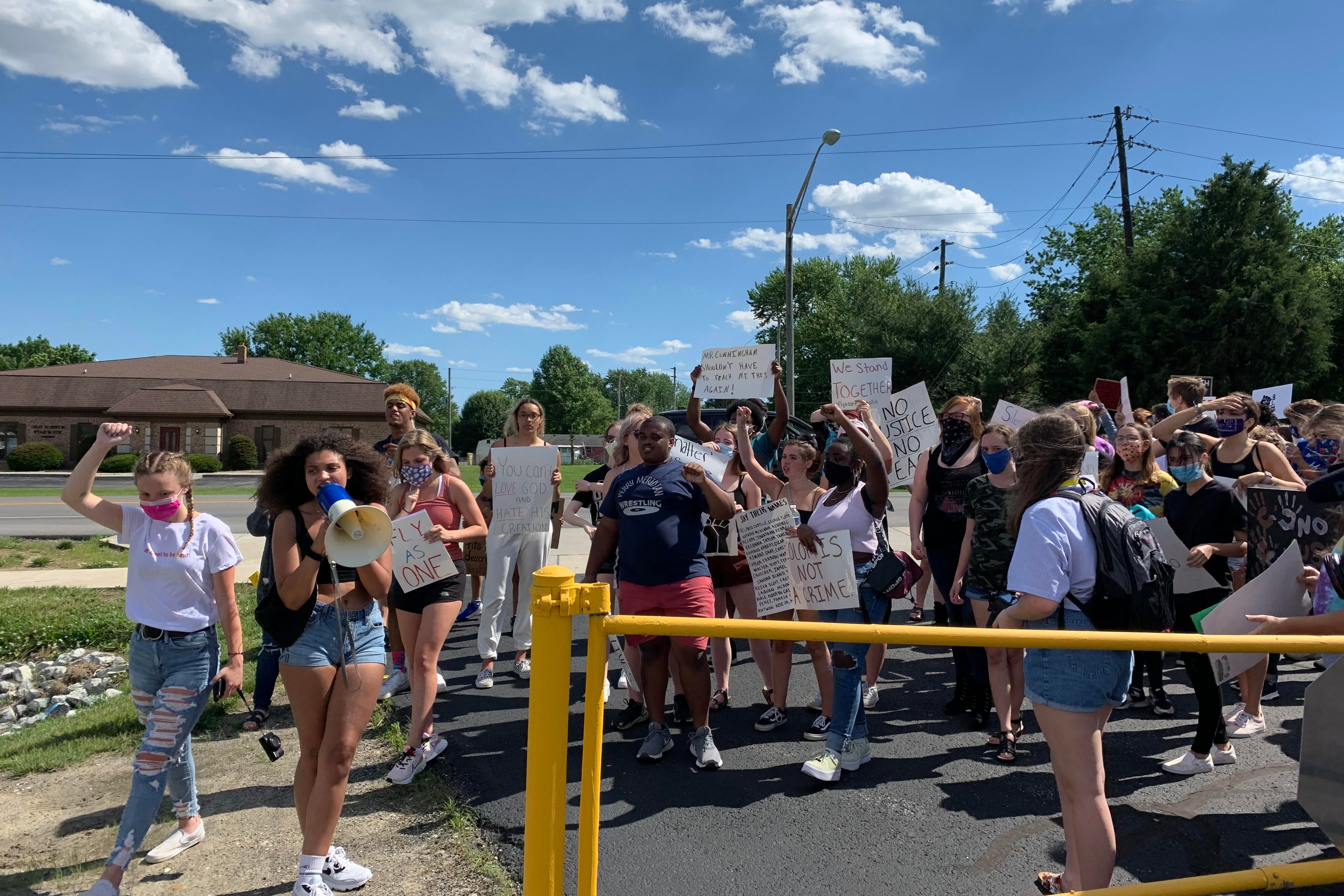 Kiara Moore leads Perry Township students in a chant June 11 as they rally for racial justice.