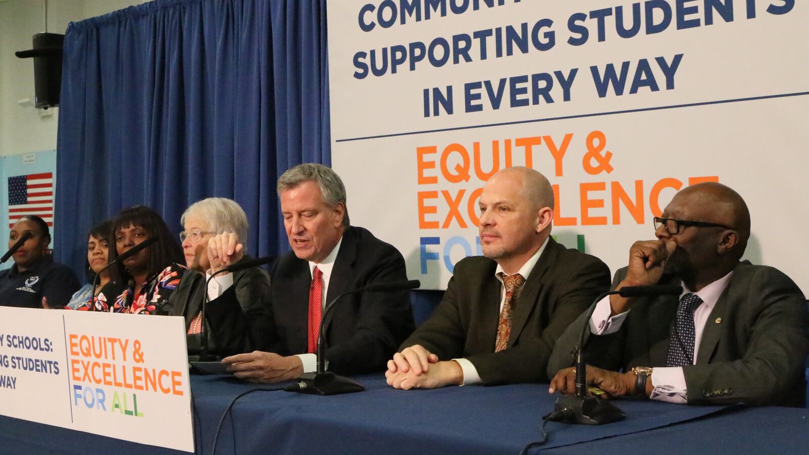 Mayor Bill de Blasio, flanked by schools Chancellor Carmen Fariña and UFT chief Michael Mulgrew announced an expansion of the city's community schools program at Brooklyn’s I.S. 155.
