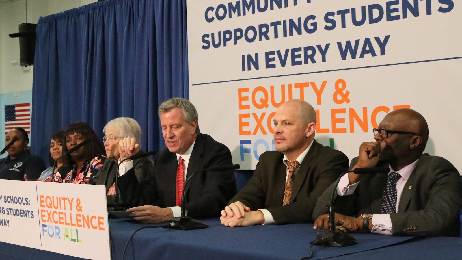 Mayor Bill de Blasio, flanked by schools Chancellor Carmen Fariña and UFT chief Michael Mulgrew announced an expansion of the city's community schools program at Brooklyn’s I.S. 155.