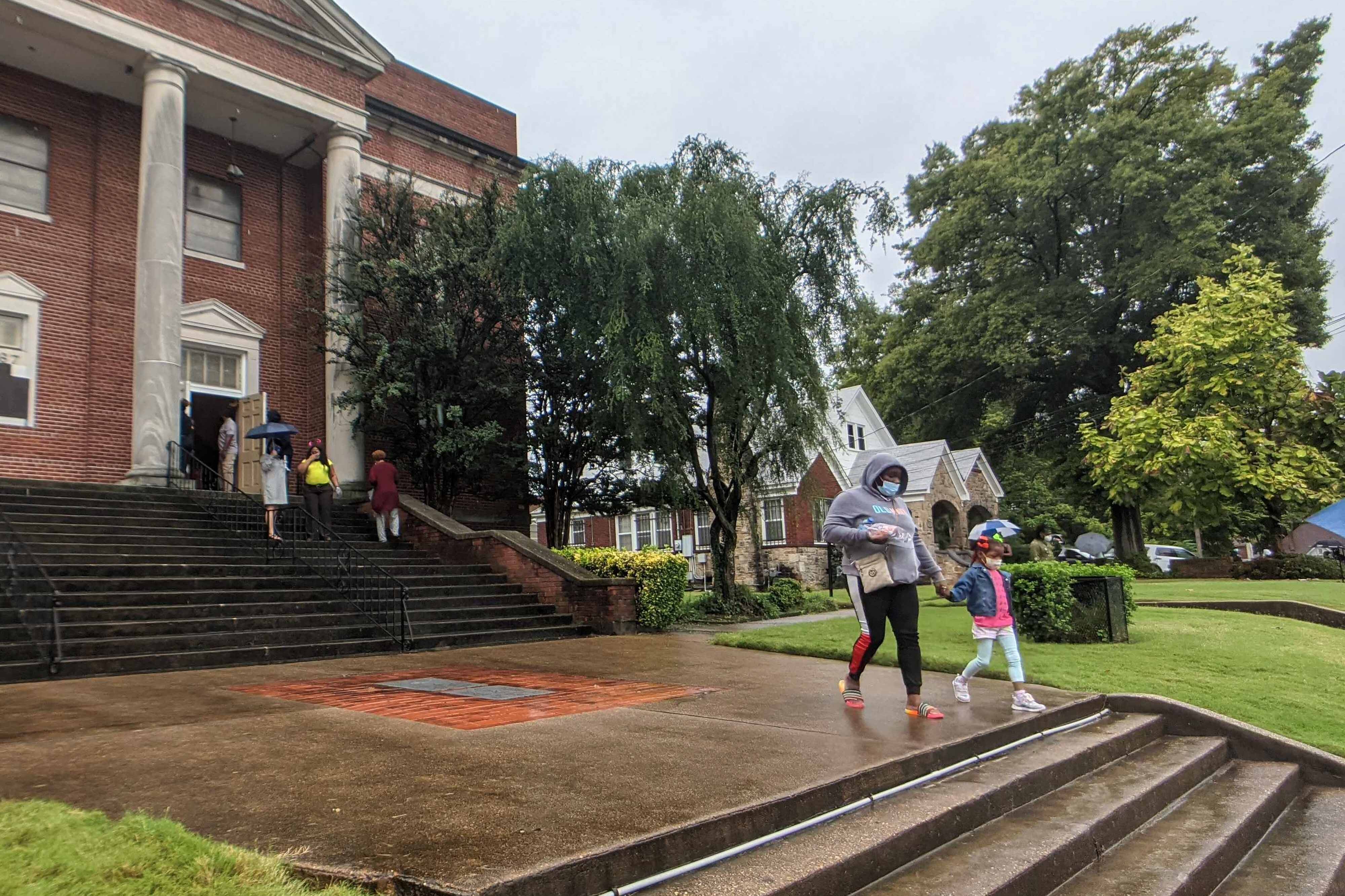 Members of the community wait for their children at Metropolitan Baptist Church following a shooting at Cummings Elementary School in Memphis.