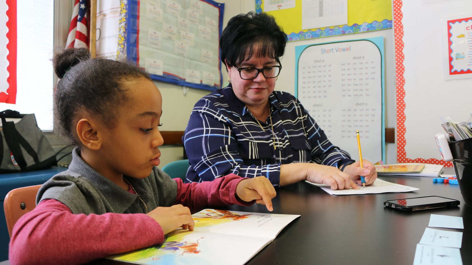 Eileen Bramer (right) conducts a reading intervention with Peyton, a first grader at P.S. 111 in Queens.