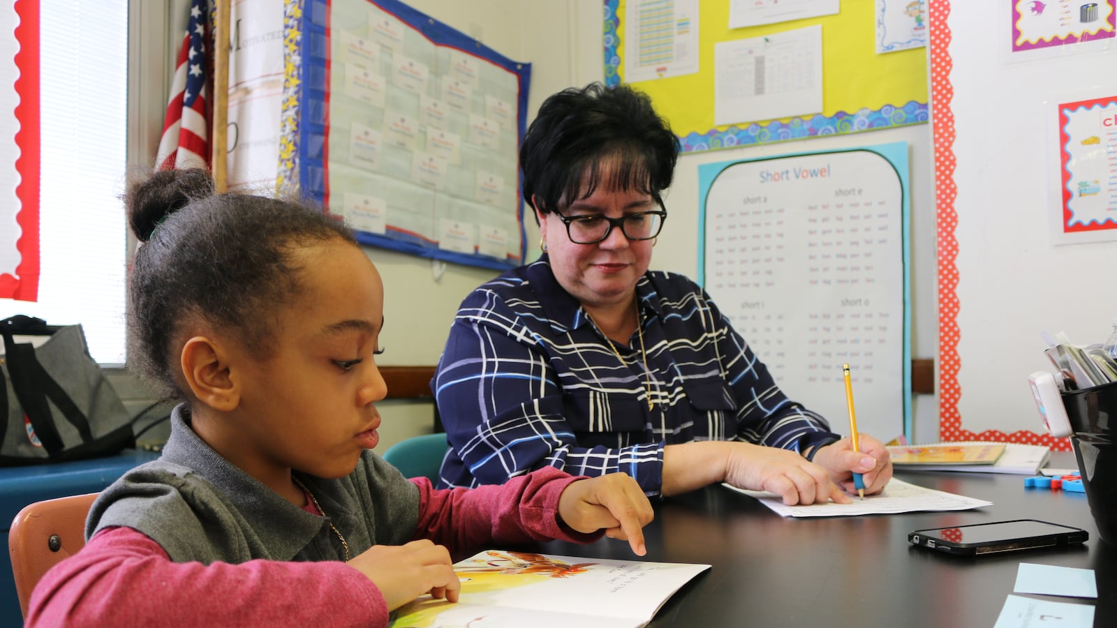 Eileen Bramer (right) conducts a reading intervention with Peyton, a first grader at P.S. 111 in Queens.