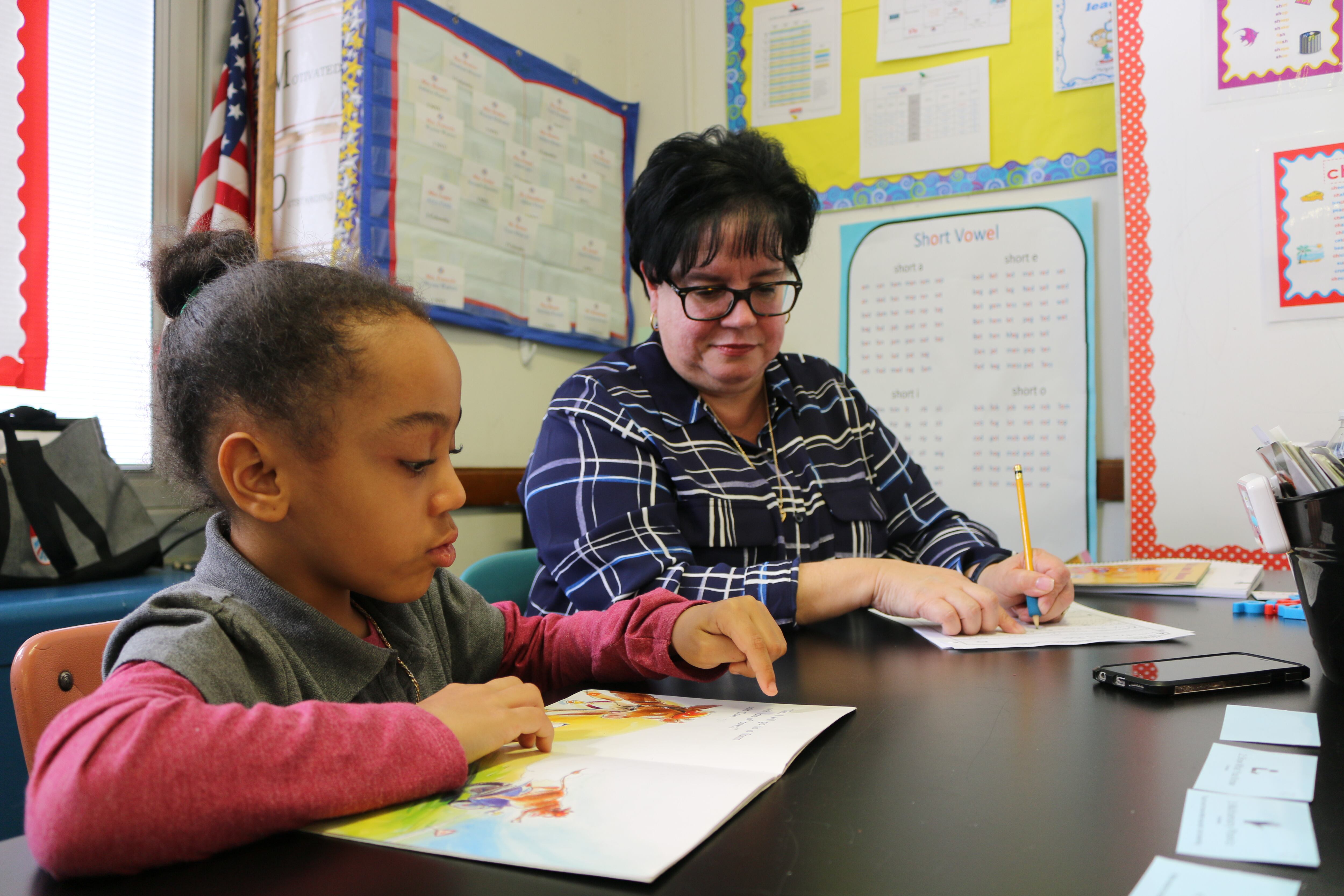 Eileen Bramer (right) conducts a reading intervention with Peyton, a first grader at P.S. 111 in Queens.