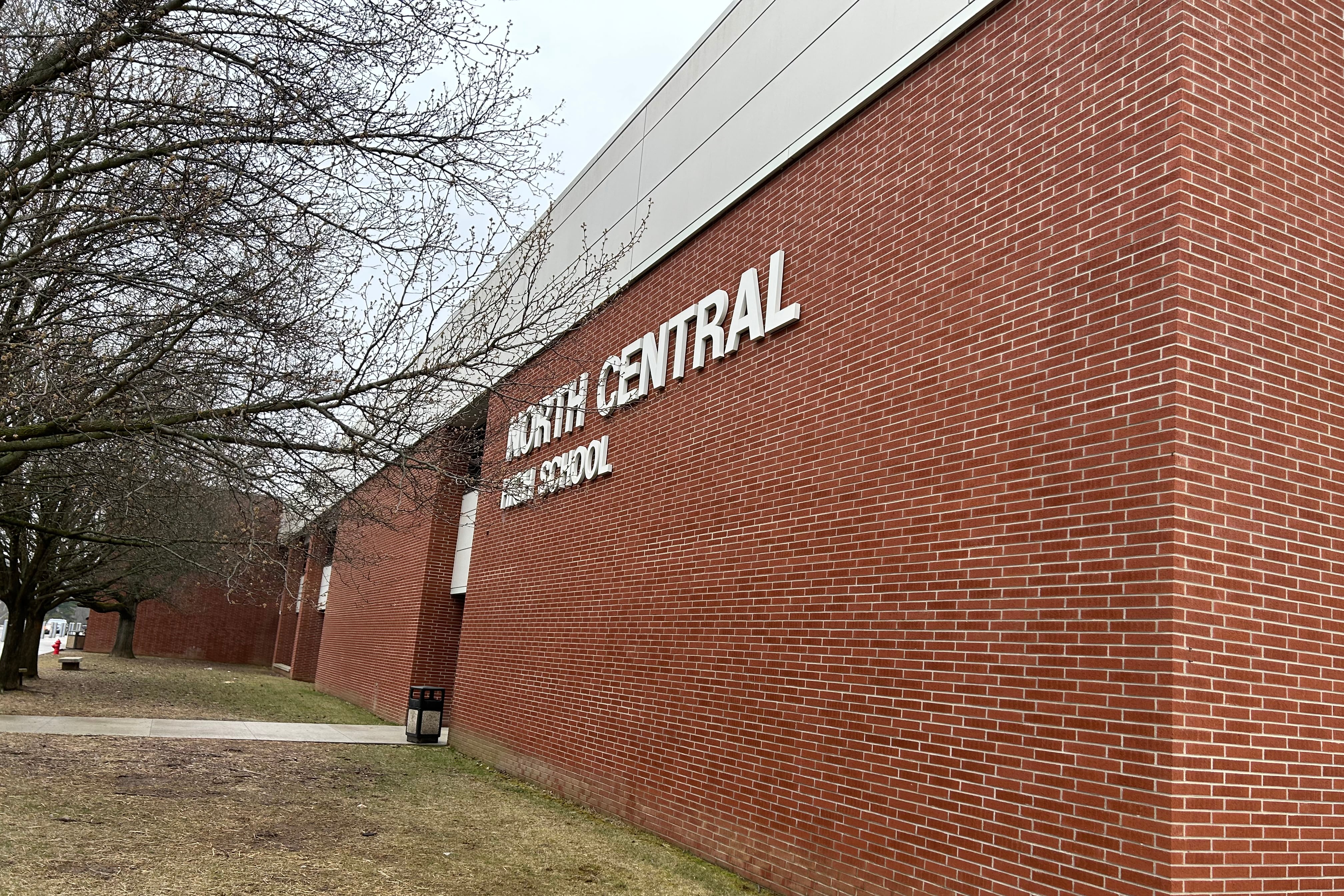 The photo shows a brick building with white letters on it that read “North Central High School.”
