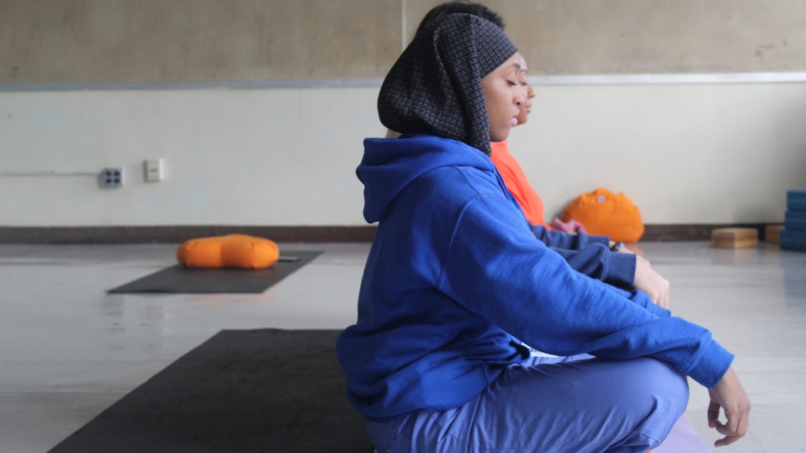 Newark high school students close their eyes and practice meditation.