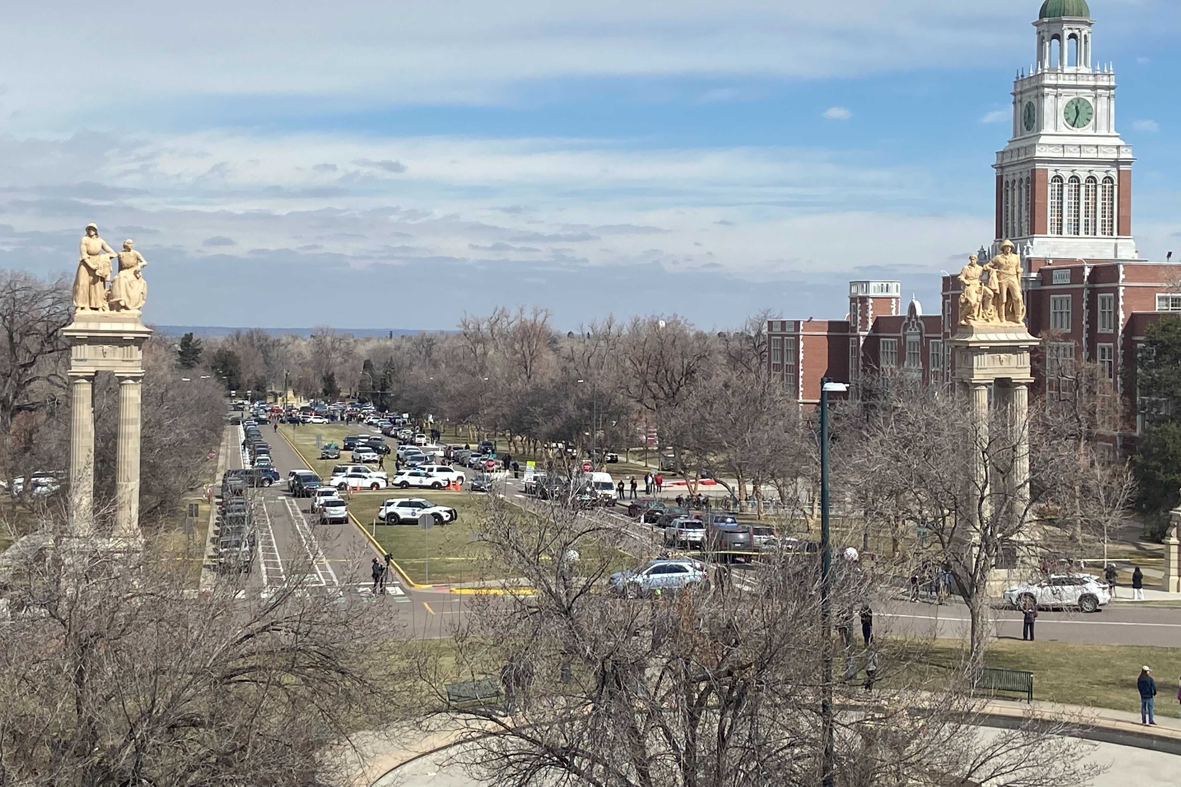 East High School and the surrounding campus full of police vehicles is seen from a distance. 