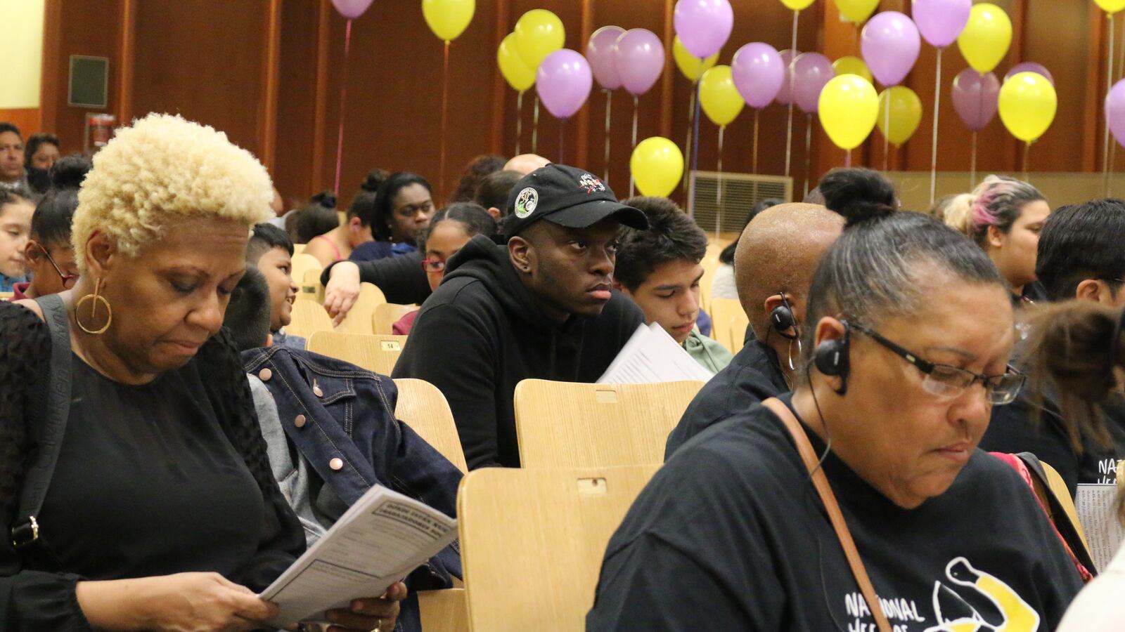 The New Settlement Parent Action committee tied balloons to empty auditorium seats to represent District 9 students who go without social workers.
