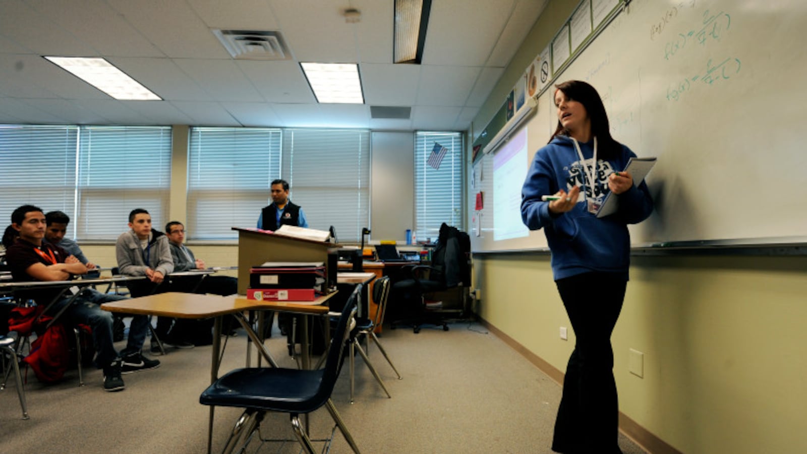 Hinkley High School student Catherine Gibson turns toward her college algebra class to explain a problem she works on the board in 2013 at Hinkley High School in Aurora, Colo. (Photo by Jamie Cotten, Special to The Denver Post)