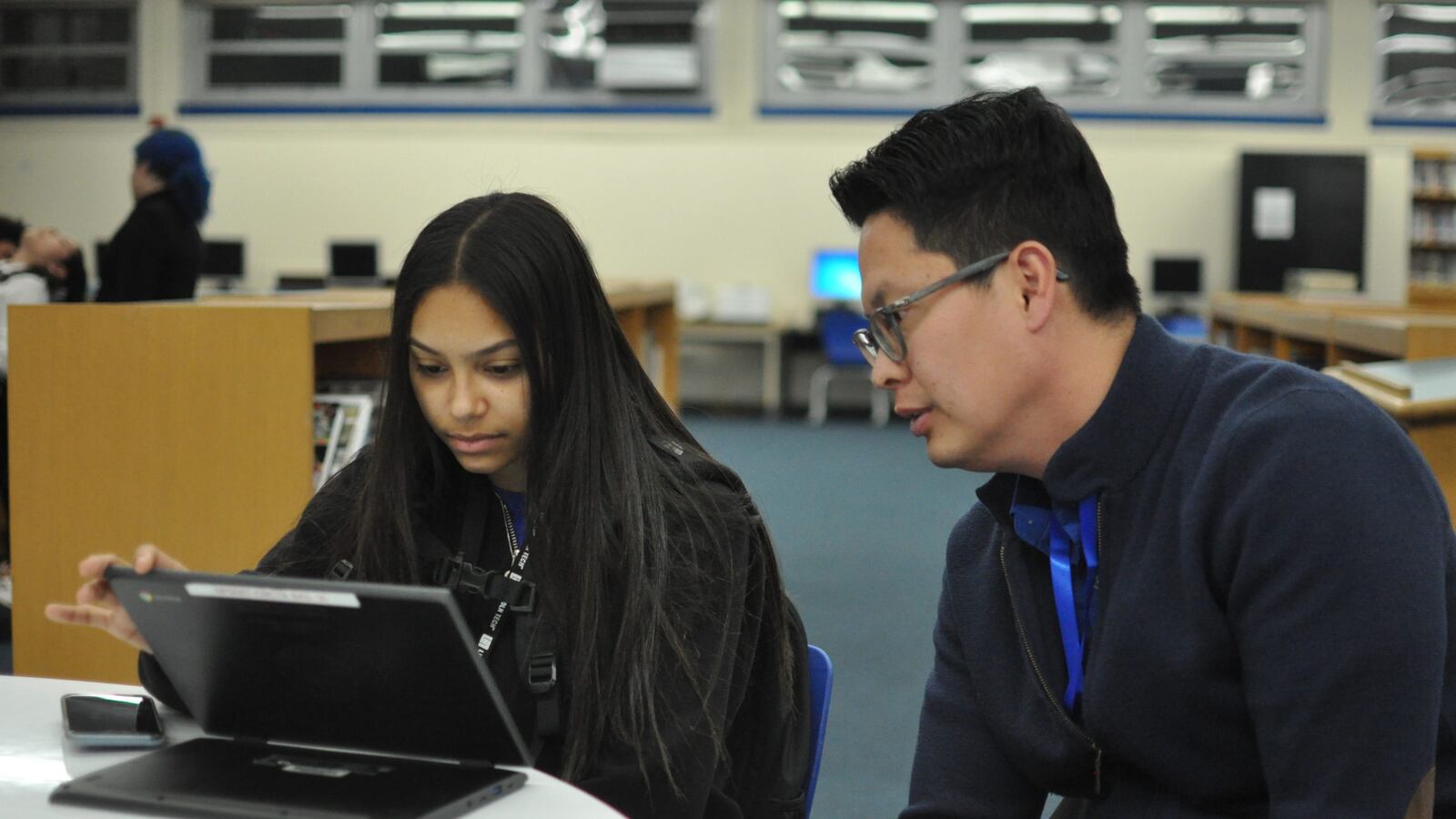 A Newark student receives assistance filling out the federal aid application Tuesday at Barringer High School.
