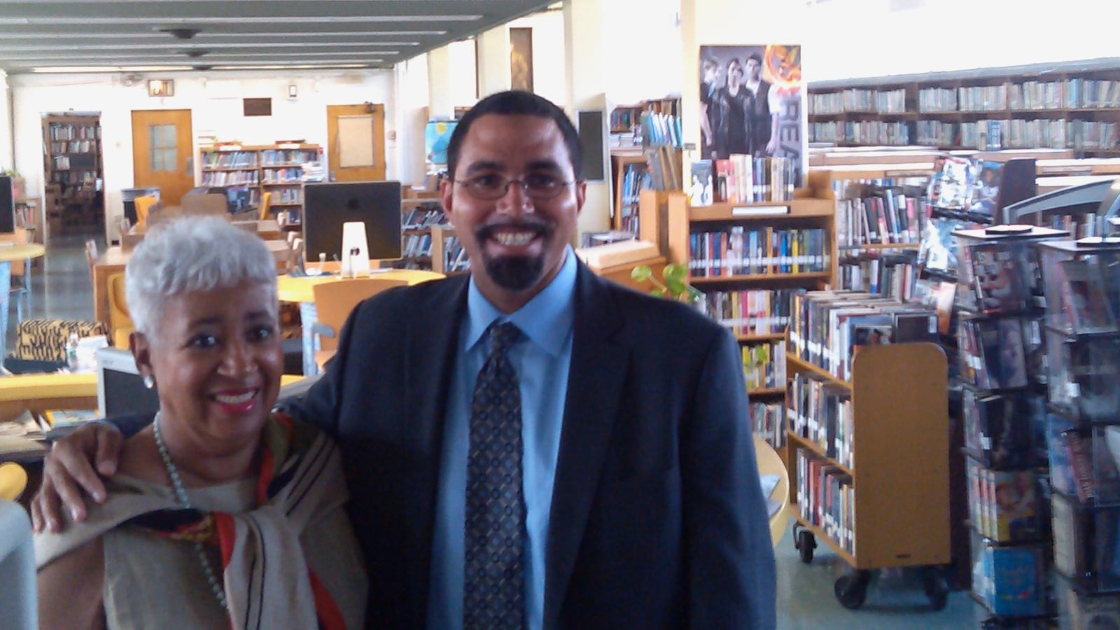 State Education Commissioner John King visits in 2013 with second cousin Stephanie Smith, a librarian at George Wingate Educational Complex since 1969.