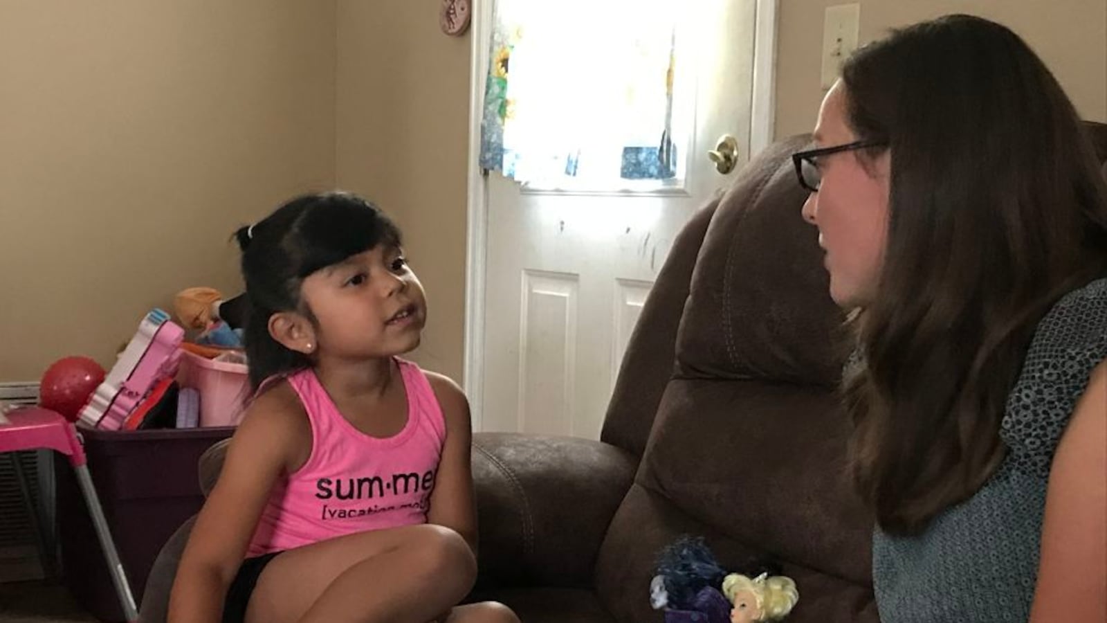Naylin Lopez, 6, talks with her teacher, Annemarie Minor, in her home.