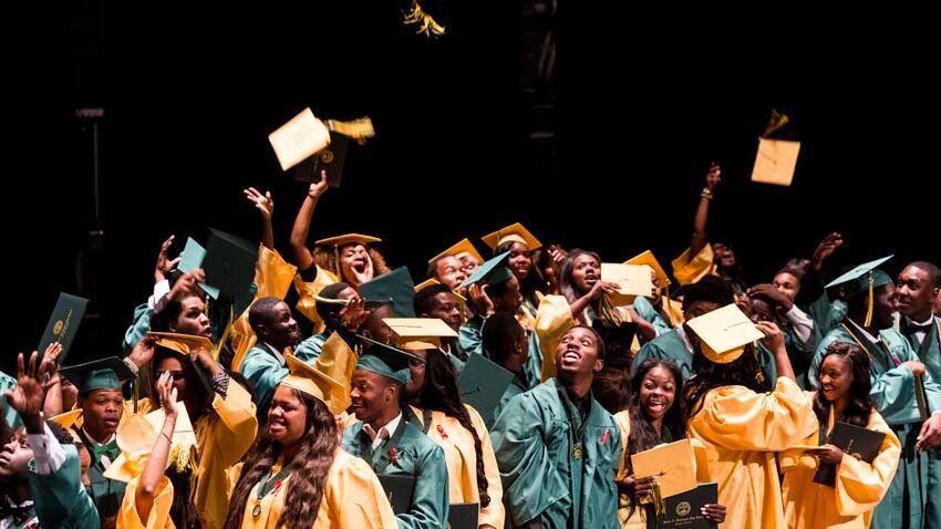 Booker T. Washington High School seniors toss their graduation caps into the air  at the conclusion of their 2016 graduation ceremony at the Orpheum Theatre.