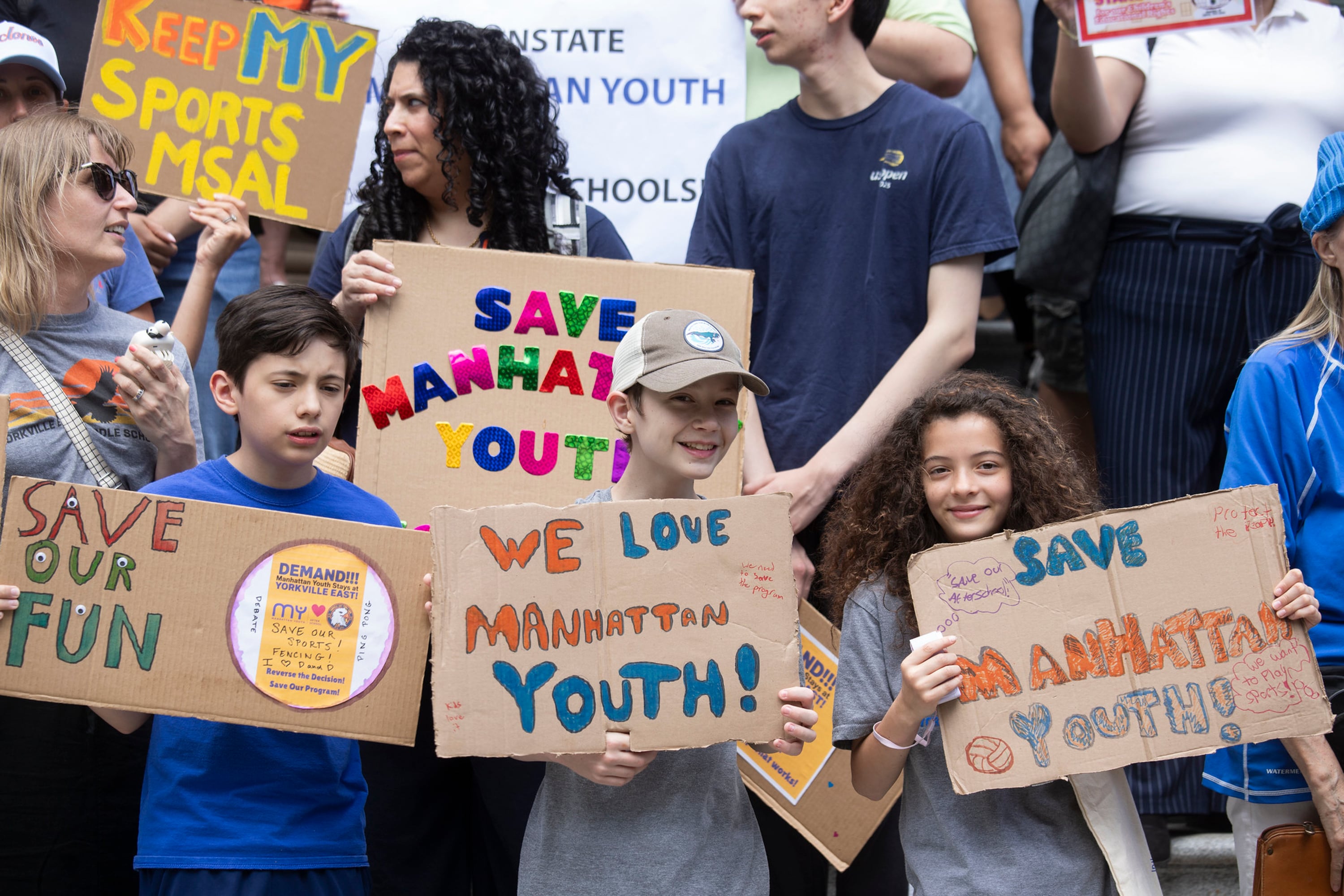 Children hold signs that read, "Save Our Fun."