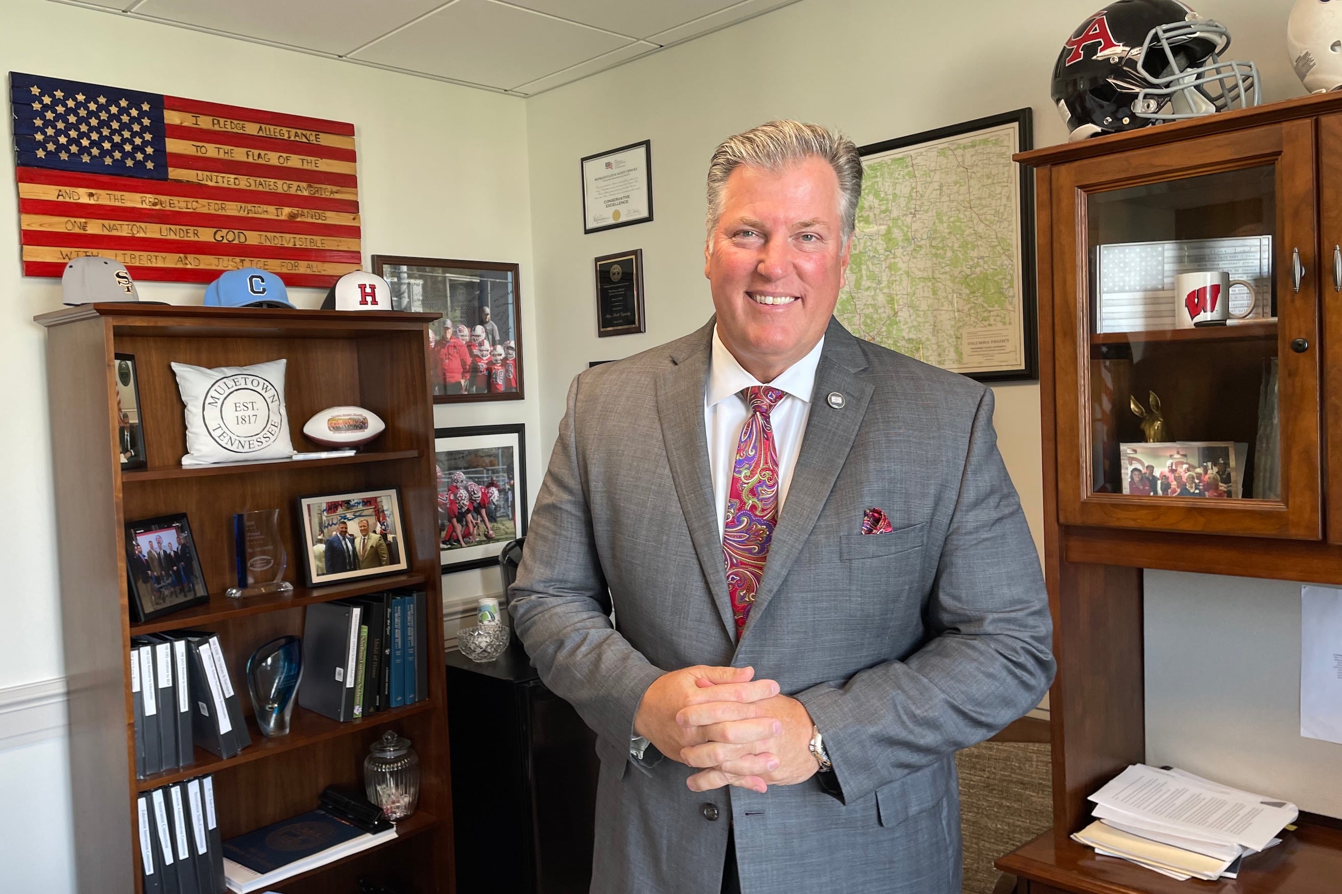 Man in gray suit and red tie in an office