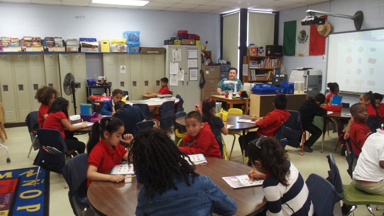 Teacher LeiRene Perez works with third-grade students in Spanish at Treadwell Elementary School in Memphis.
