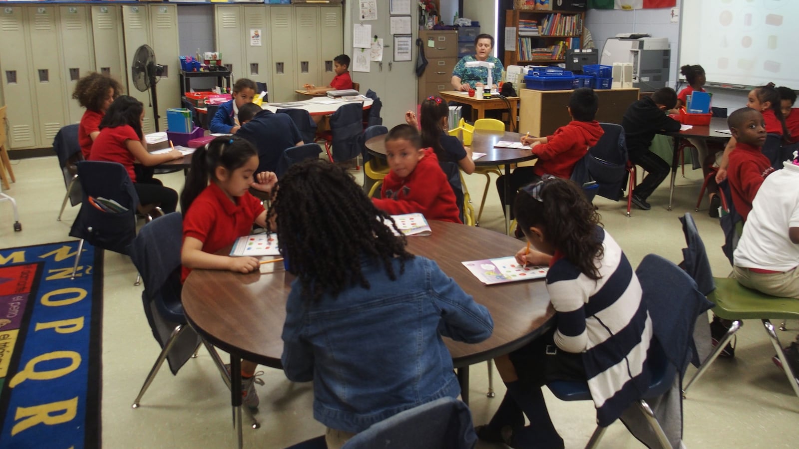 Teacher LeiRene Perez works with third-grade students in Spanish at Treadwell Elementary School in Memphis.