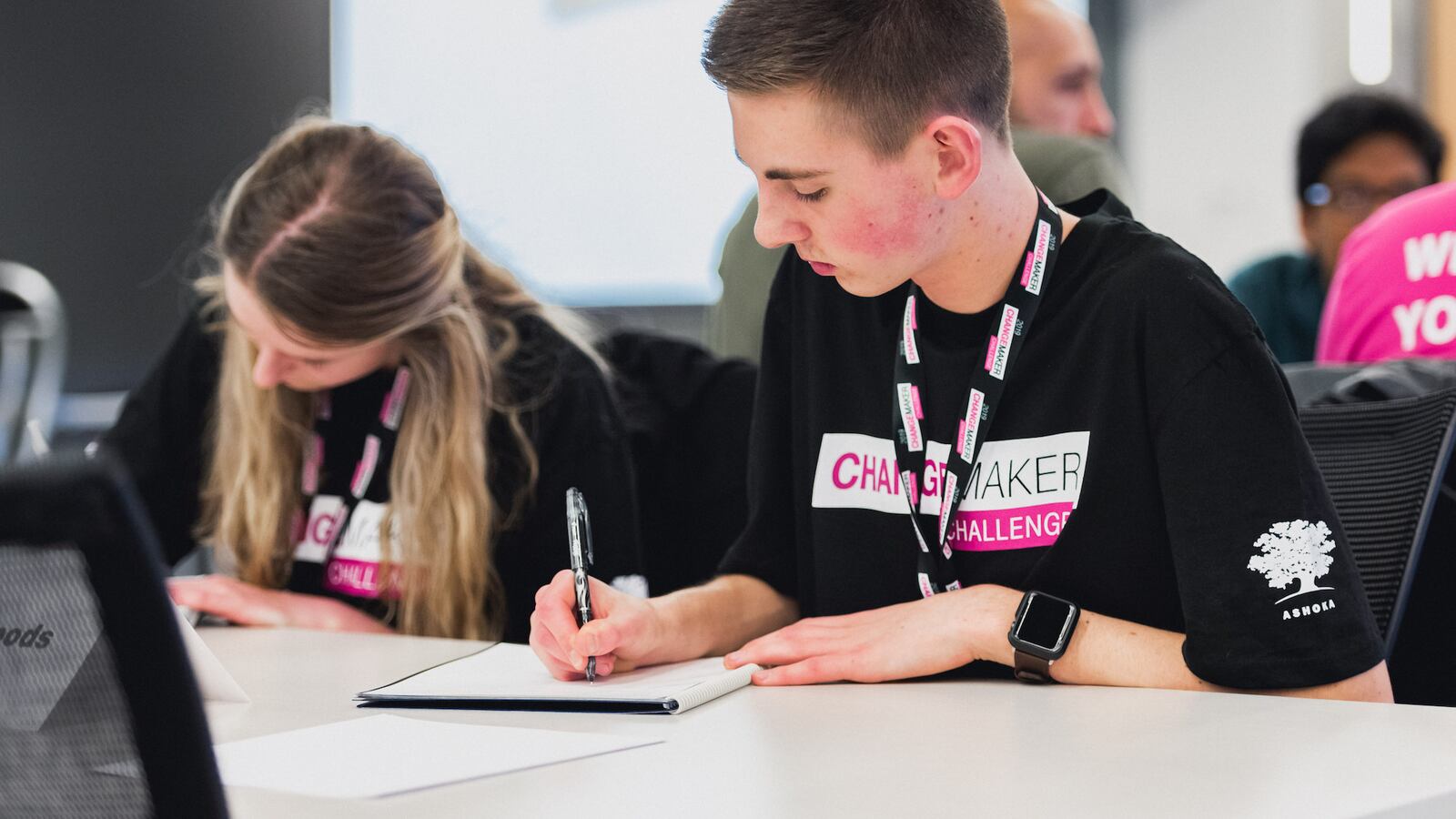 2 students seated at a desk participate in T-Mobile’s Changemaker Challenge