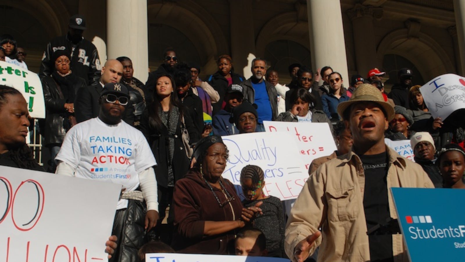 Keoni Wright, right, one of the parents expected to file a lawsuit against job protections for teachers. Wright spoke at a StudentsFirstNY rally outside City Hall in 2012.