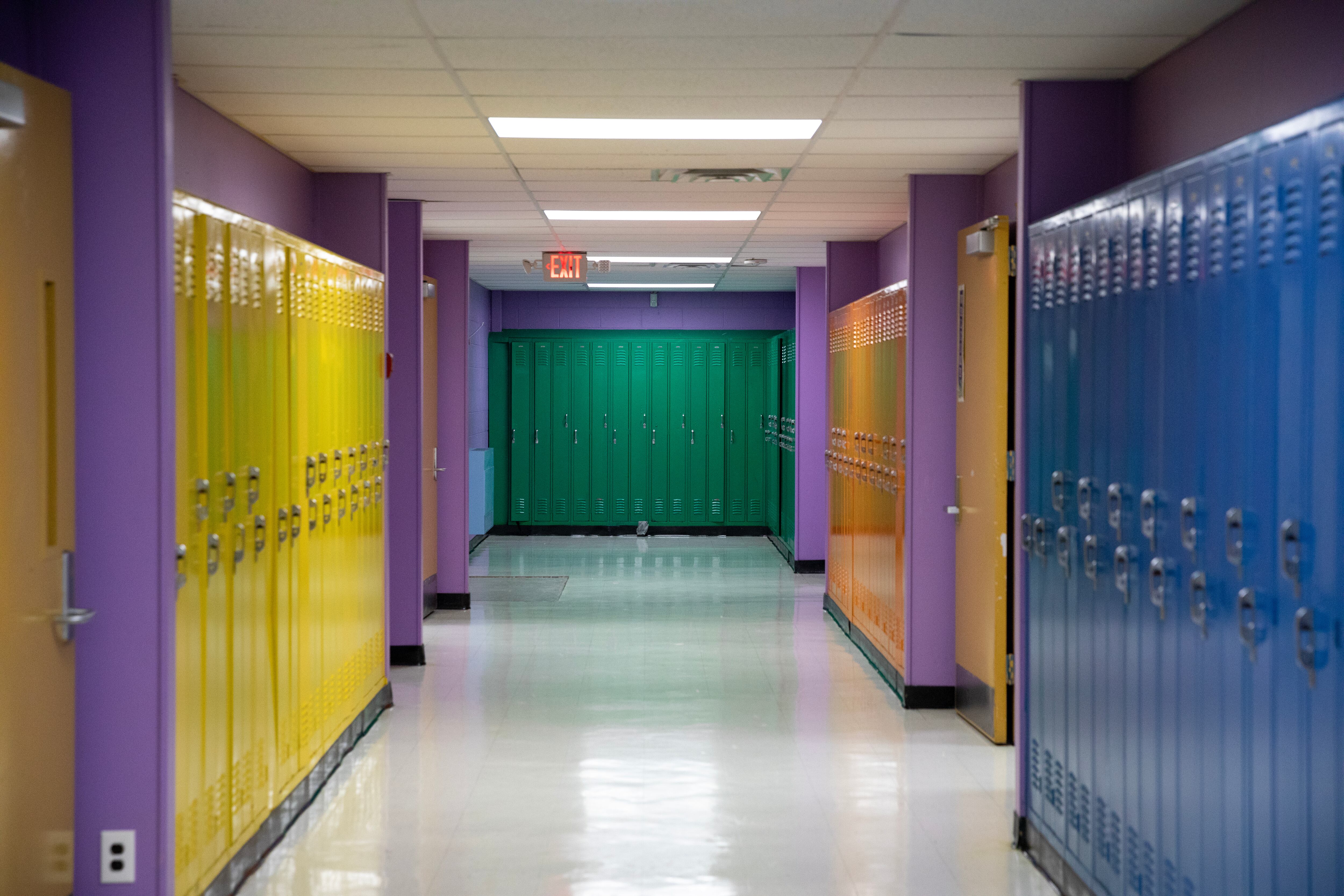 An empty school hallway lined with lockers.