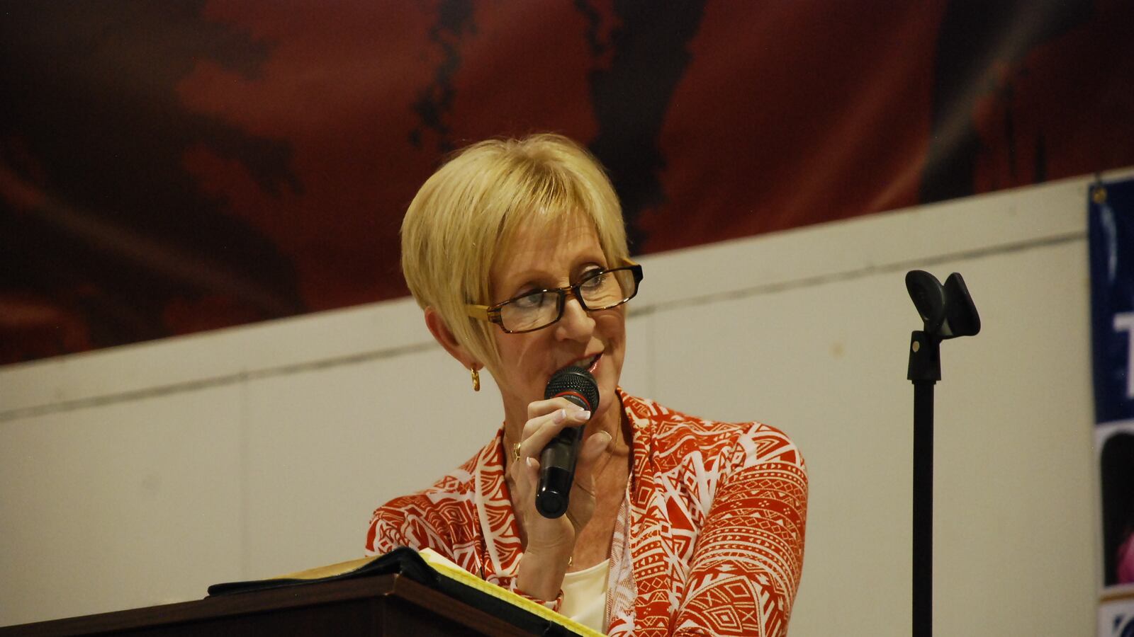 Nora Flood addresses an audience at a school board forum in Jefferson County.