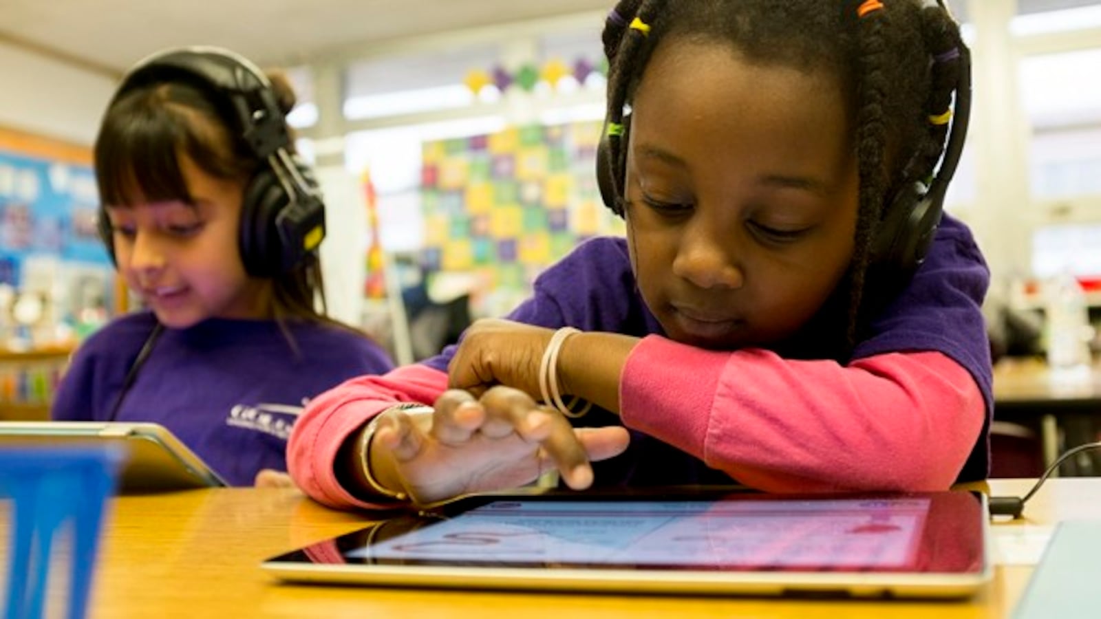 A young student works on an iPad.