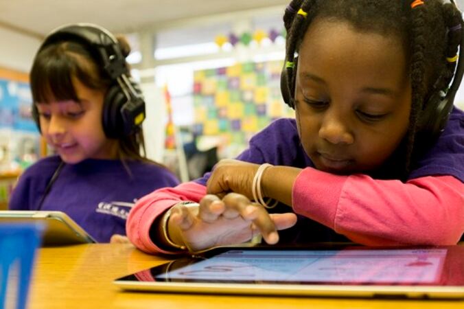 A young student works on an iPad.