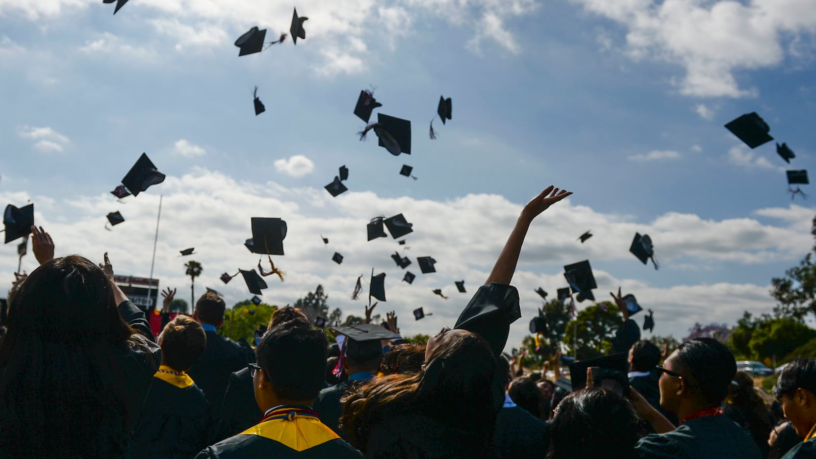 Graduates toss their caps in Fullerton, California. (Photo by Kevin Sullivan/Digital First Media/Orange County Register via Getty Images)