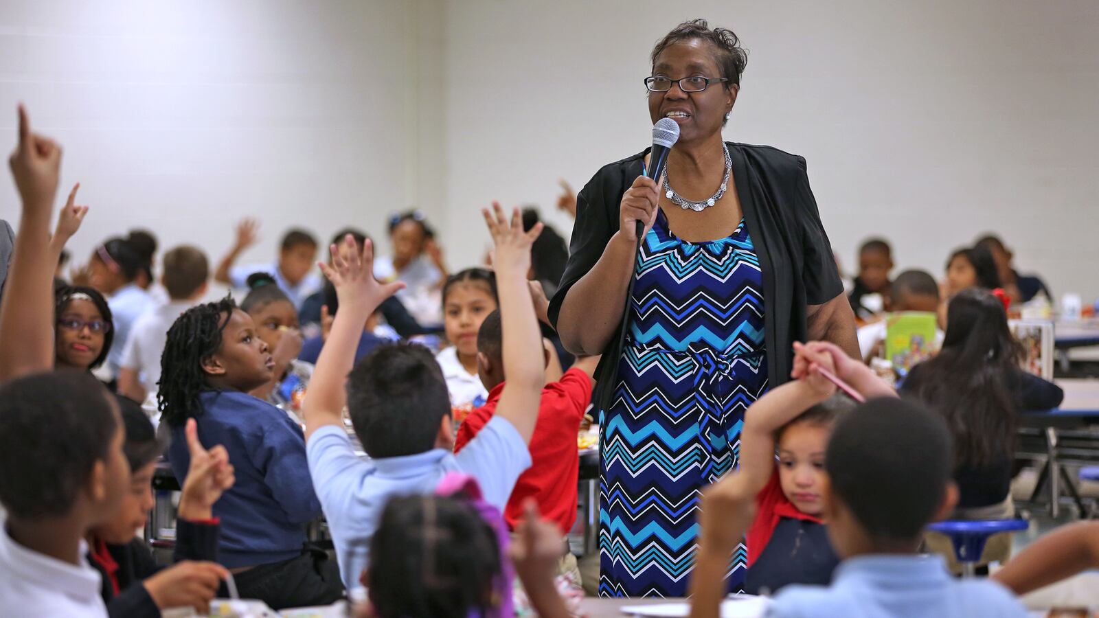 Principal Joyce Akridge tries to squeeze in learning at every moment, like at lunchtime, at IPS School 79.
