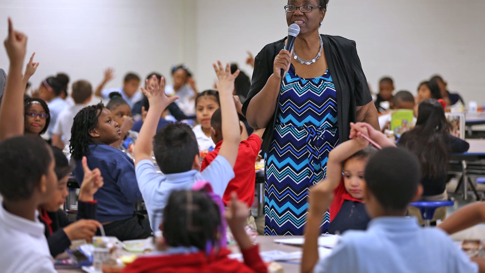Principal Joyce Akridge tries to squeeze in learning at every moment, like at lunchtime, at IPS School 79.