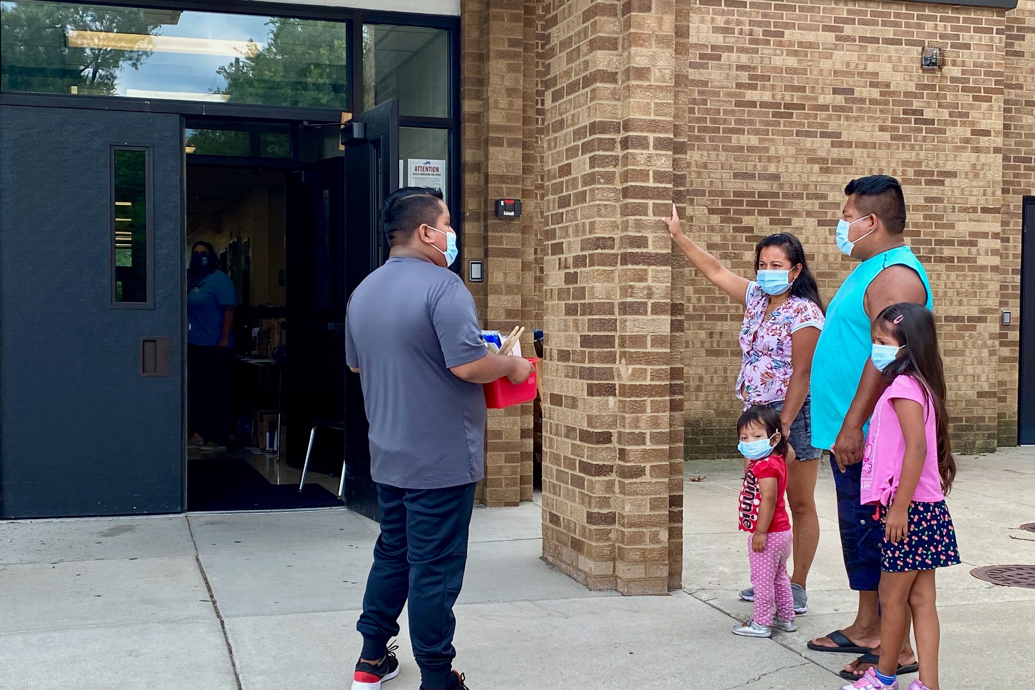 A family picks up school supplies at Indianapolis Public Schools School 87.