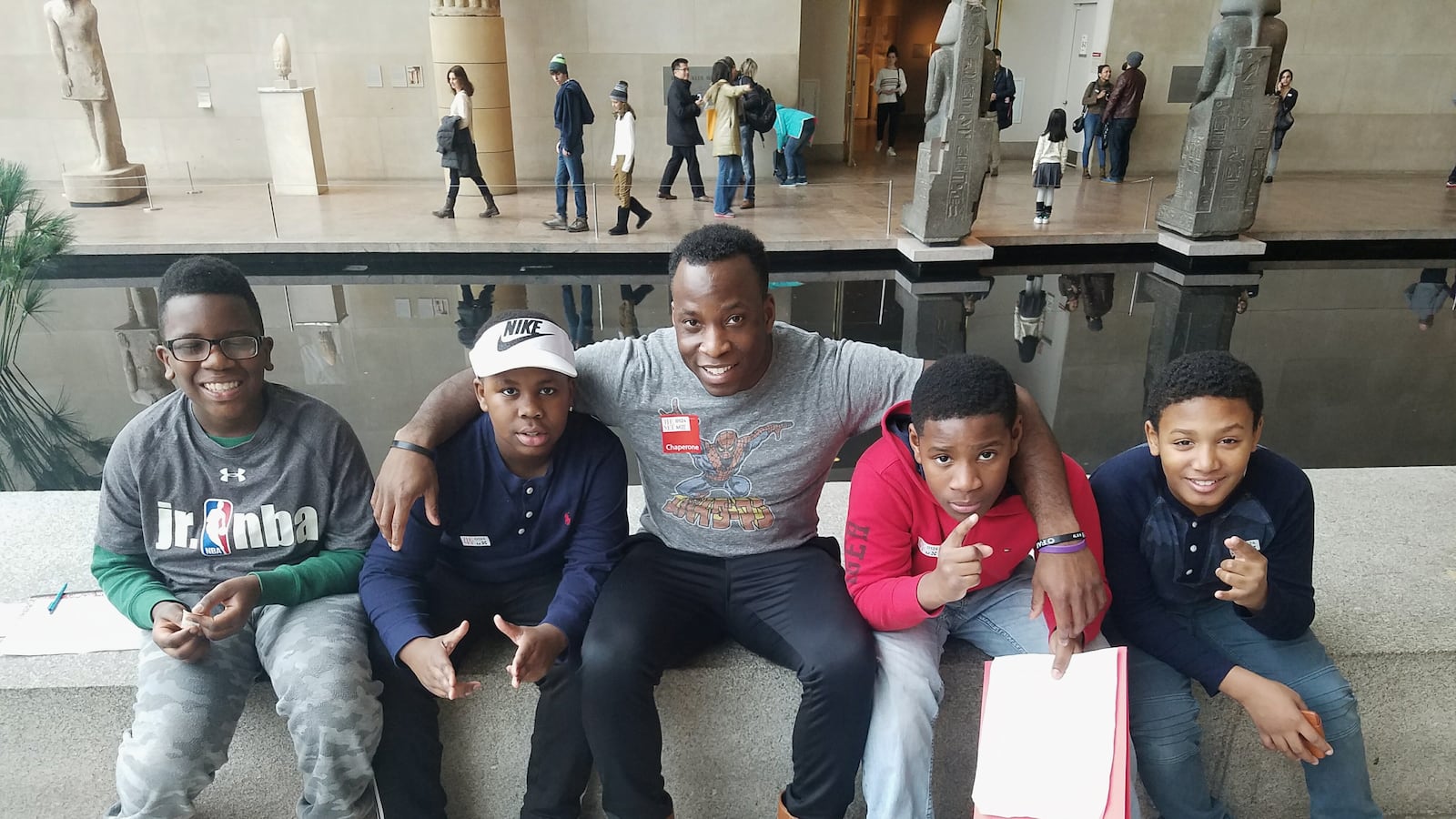 Caleb Asomugha embraces his students while on a field trip.