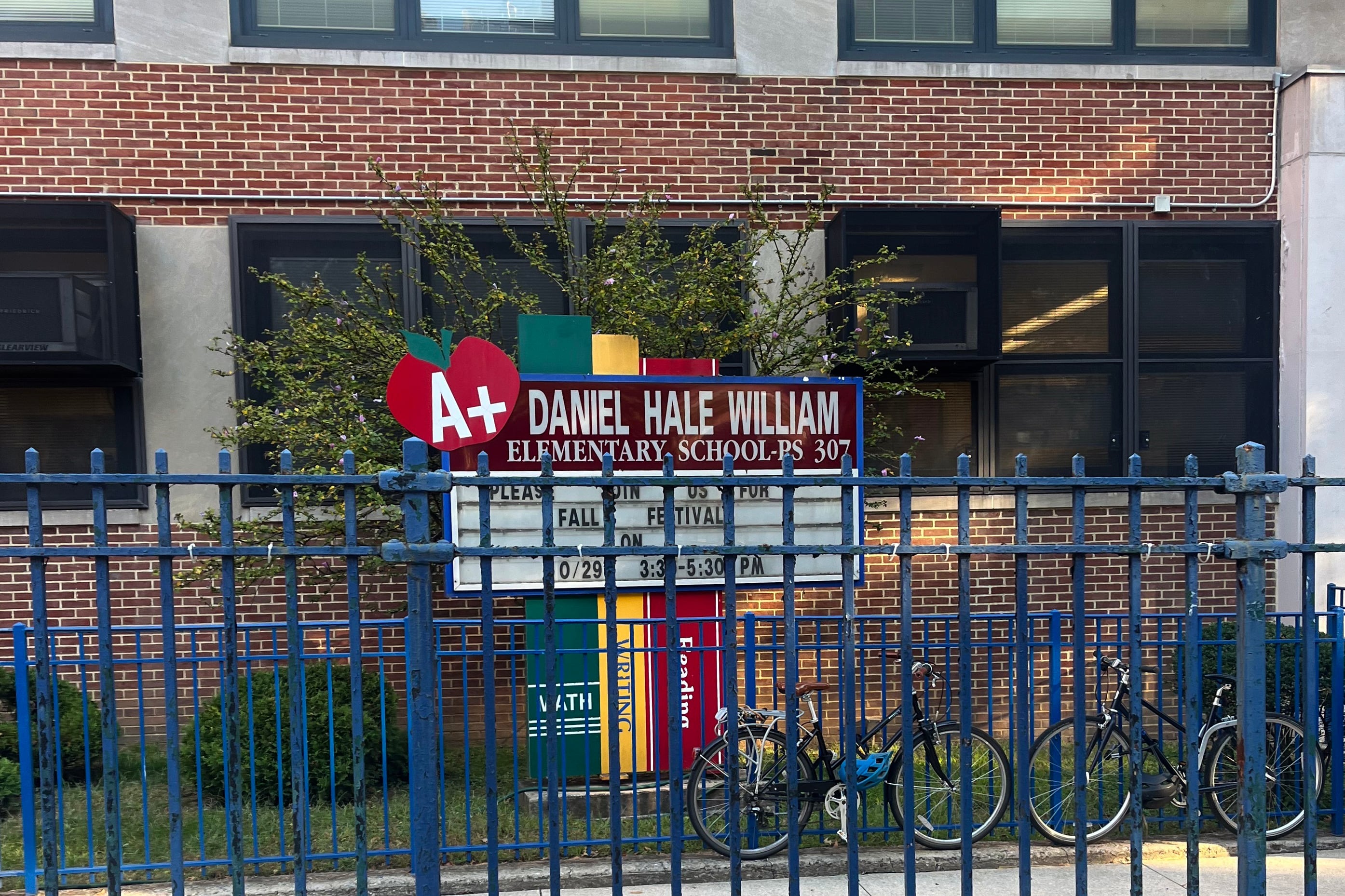 The outside of a school building on a sunny fall day.
