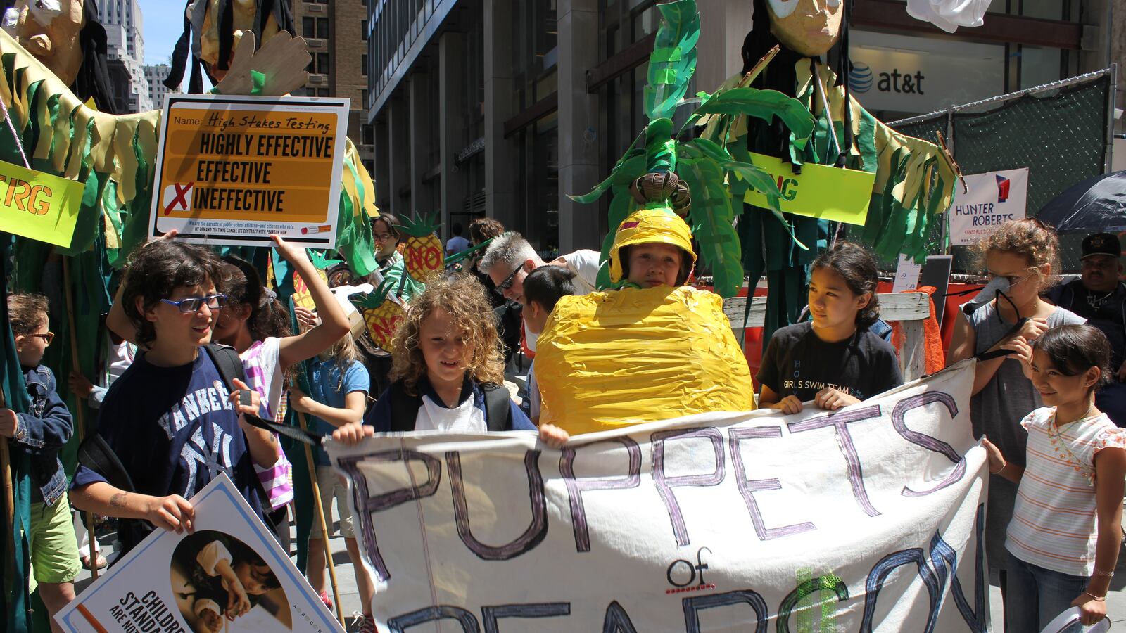 Parents and children rally against the field testing.